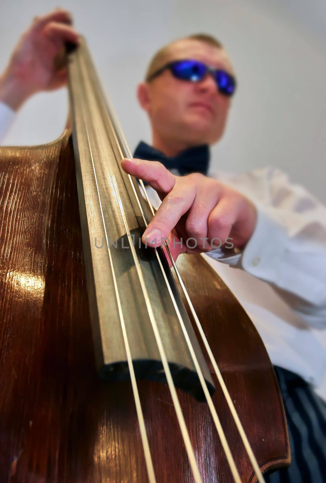 Hands of a musician playing the double bass. Jazz musician performs at a concert.