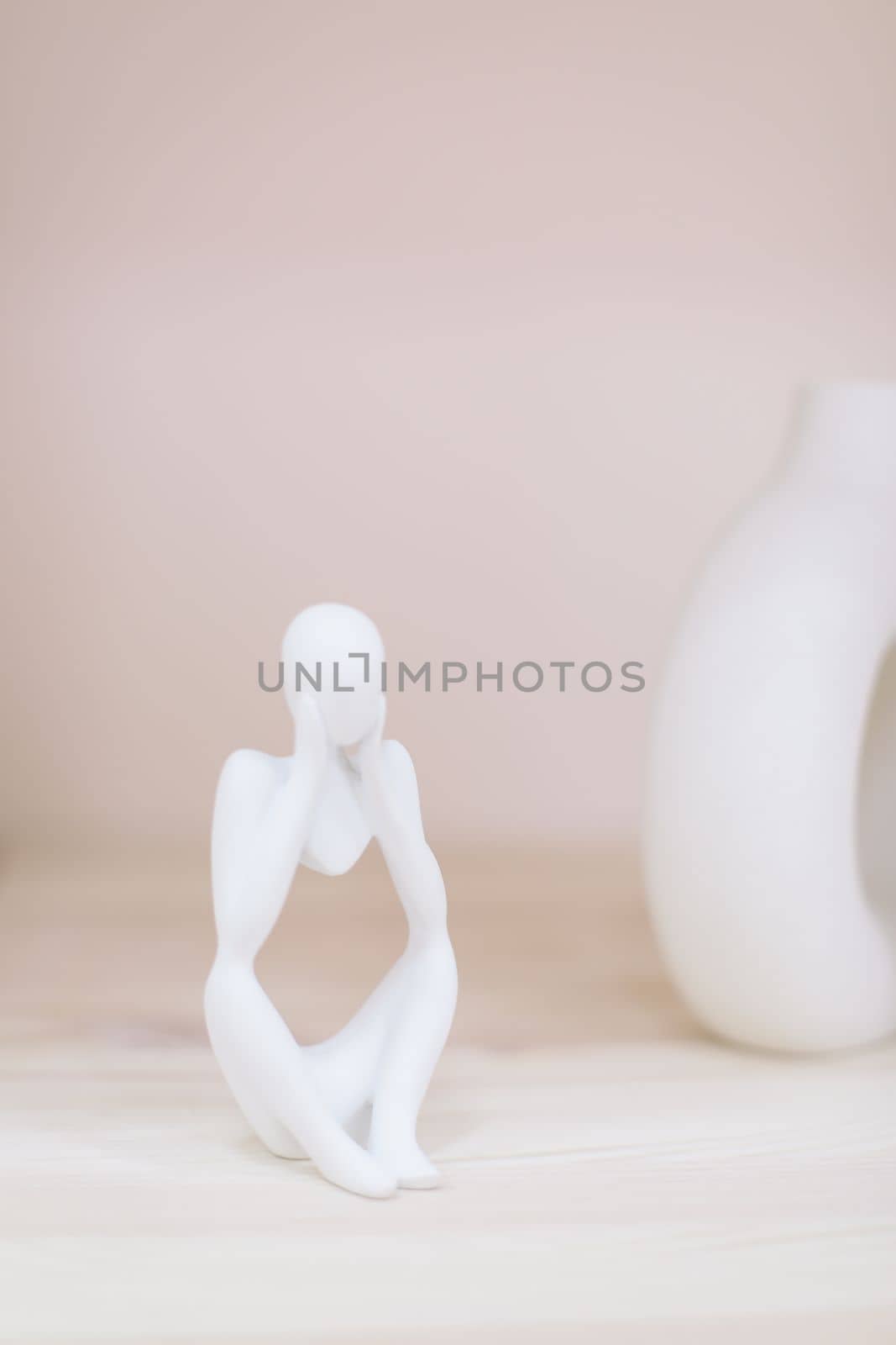 White gypsum decorative figure against beige background with copy space. Concept of template for website or commercial banner.