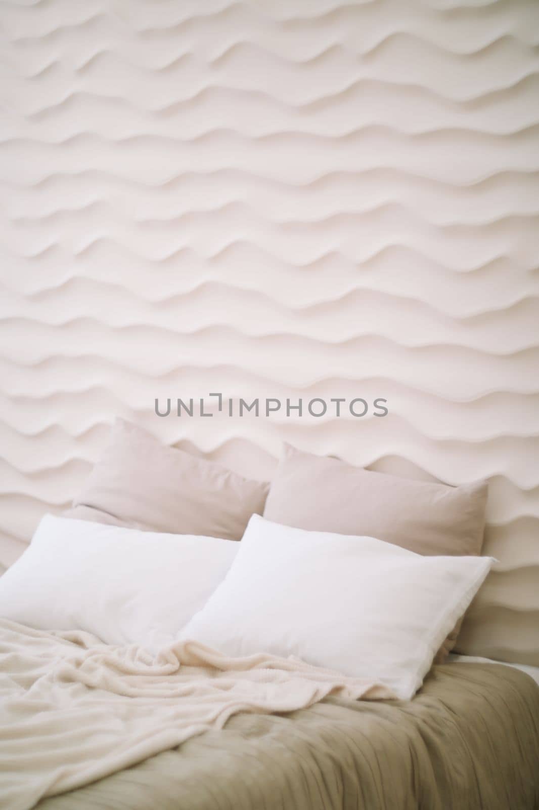 White bedroom interior. Stylish interior of contemporary room with comfortable bed.