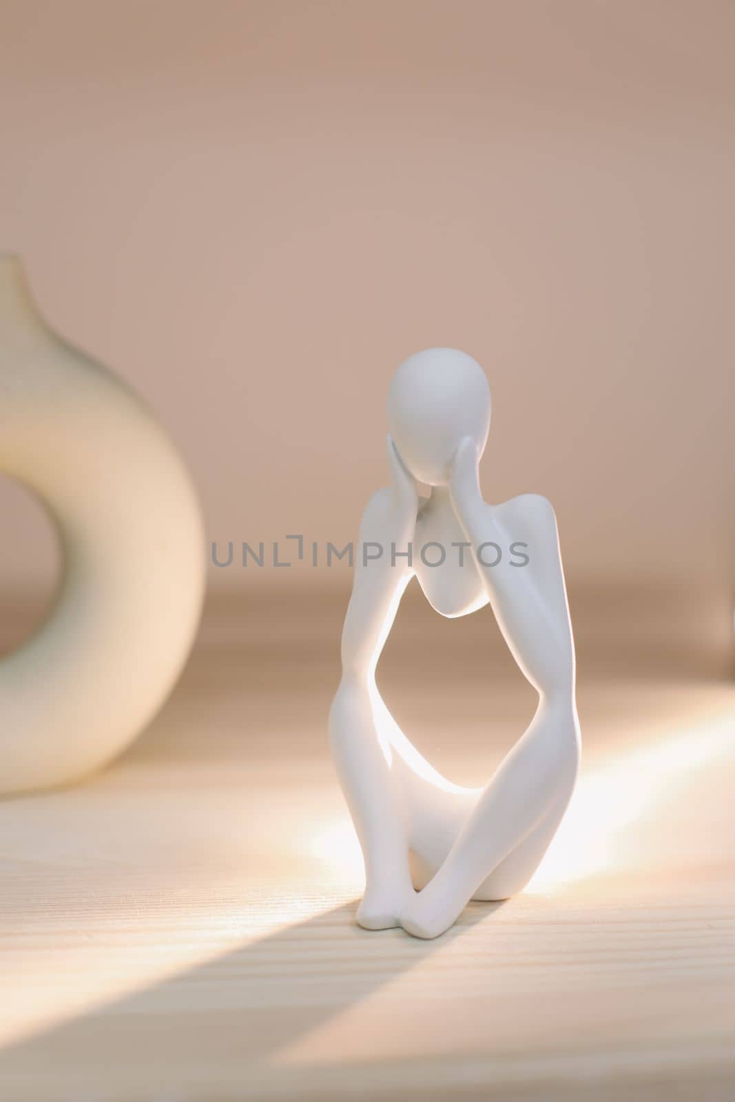White gypsum decorative figure against beige background with copy space. Concept of template for website or commercial banner.