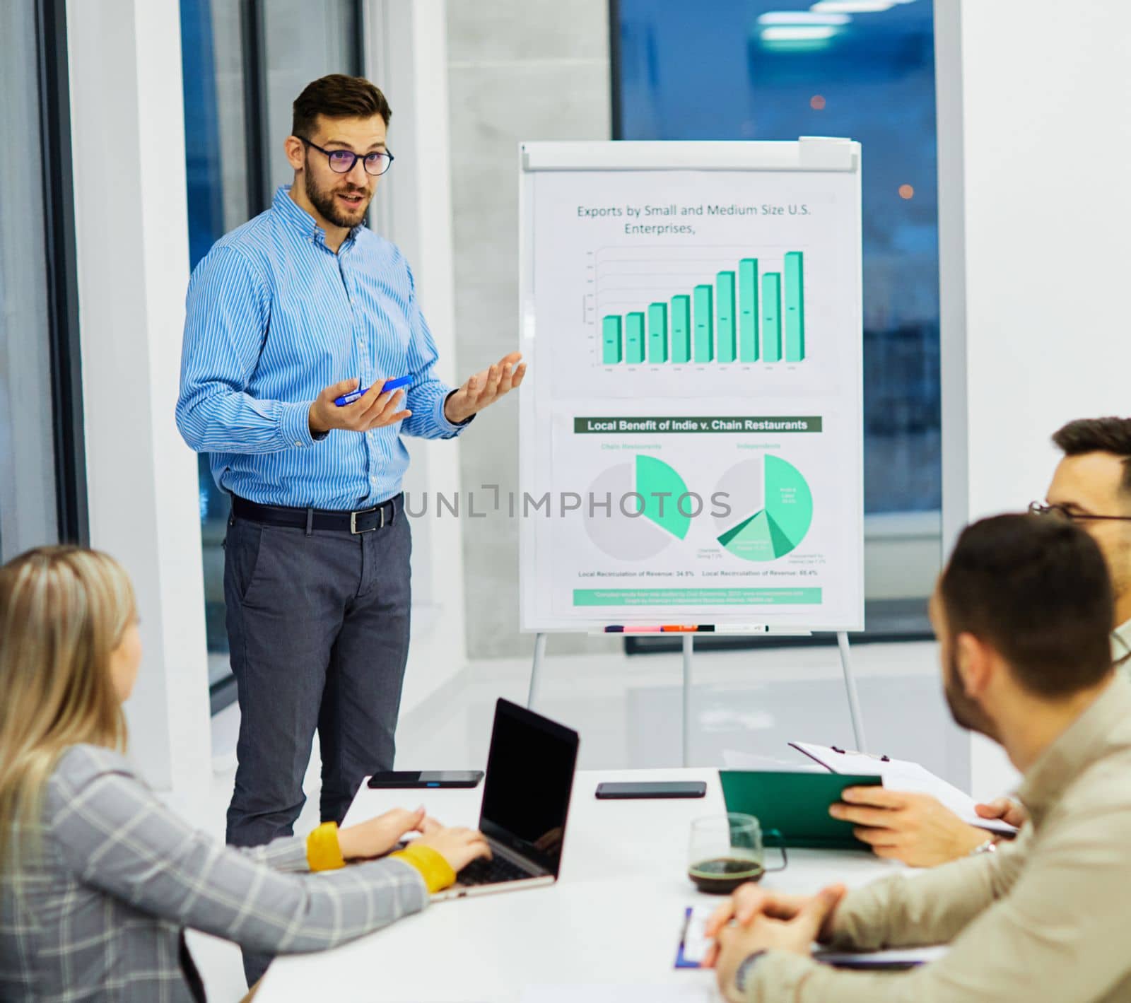 Group of young business people having a meeting or presentation and seminar with whiteboard in the office. Portrait of a young business man