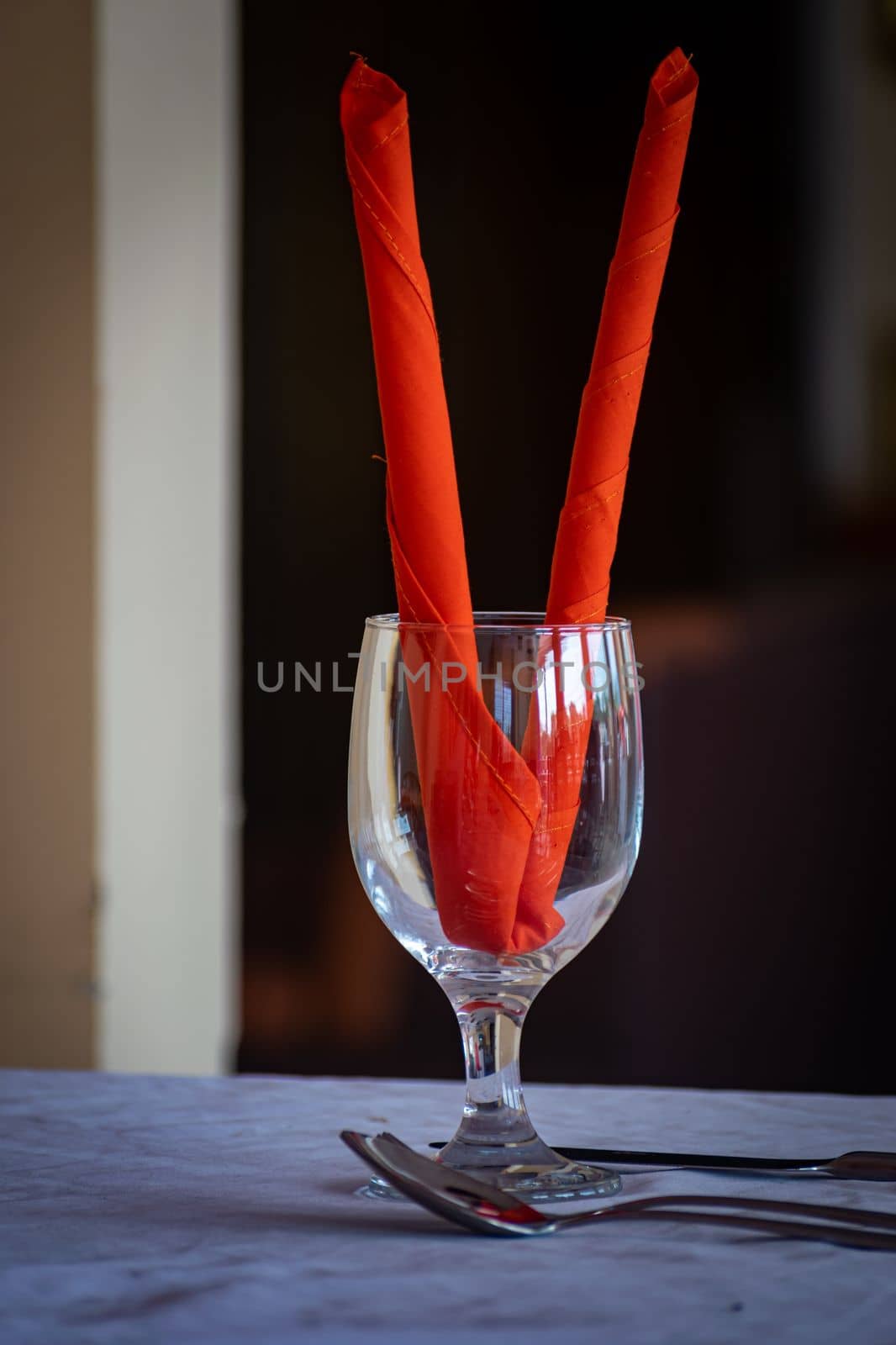Unique Water Glass on the table at a restaurant, Restaurant drink water glass with red decoration, selective focus, blur background