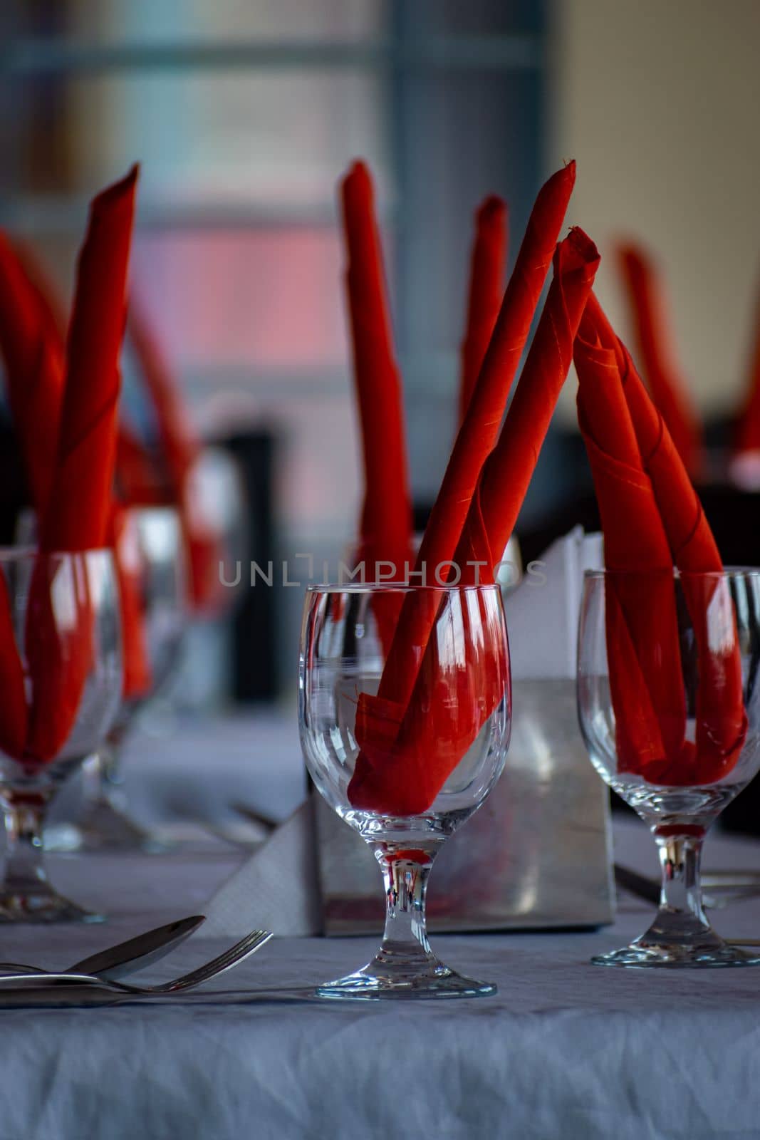 Unique Water Glass on the table at a restaurant, Restaurant drink water glass with red decoration, selective focus, blur background