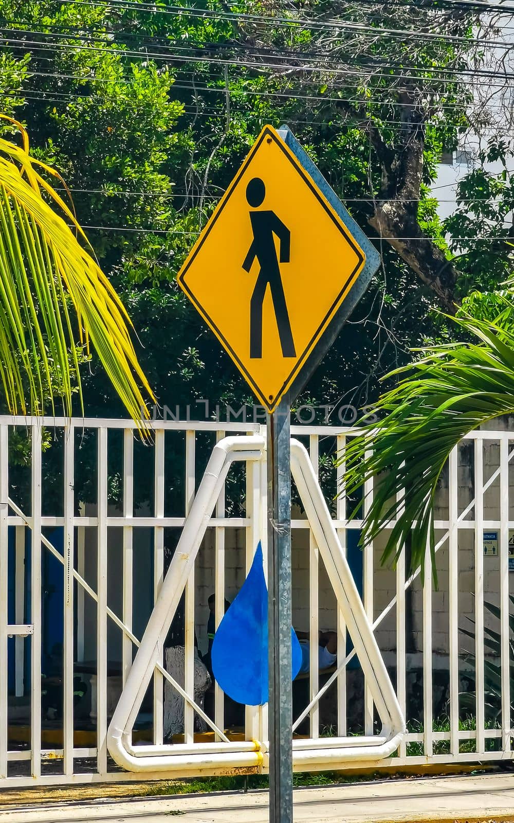 Yellow pedestrian sign street signin Playa del Carmen Mexico. by Arkadij