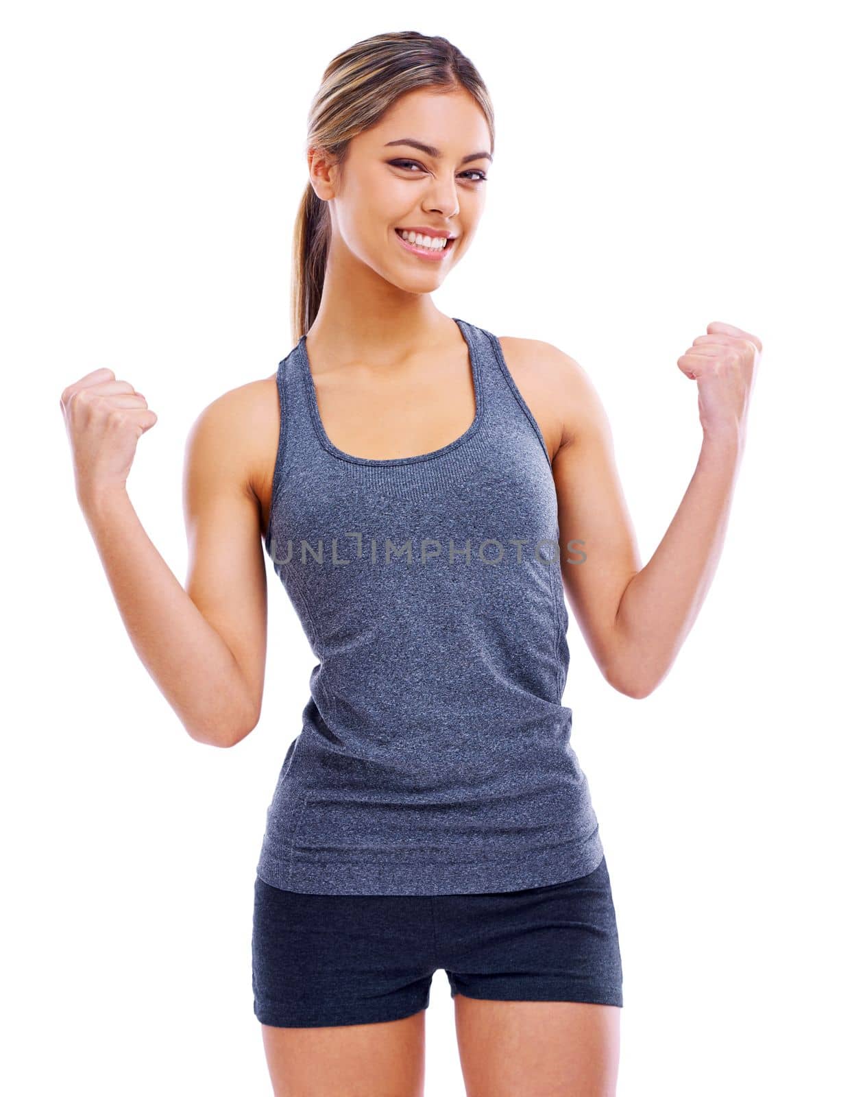 I did it. Studio portrait of an attractive woman wearing sports clothing looking enthusiastically happy. by YuriArcurs