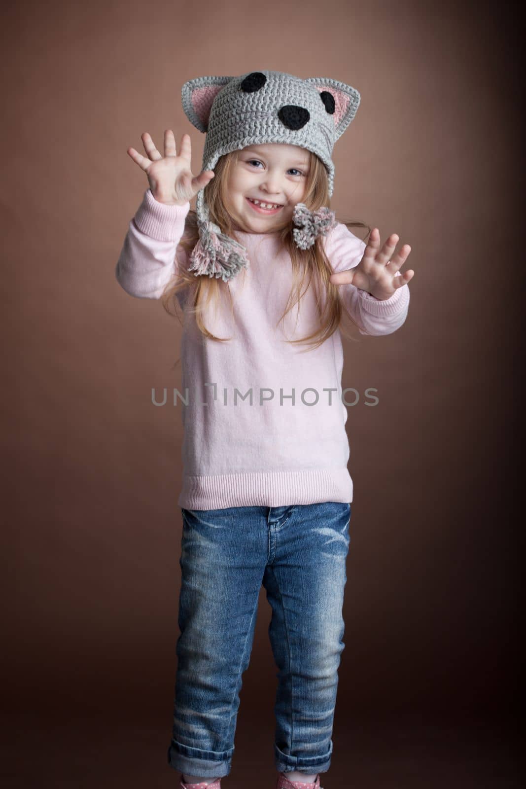 Studio portrait of little girl in cat costume