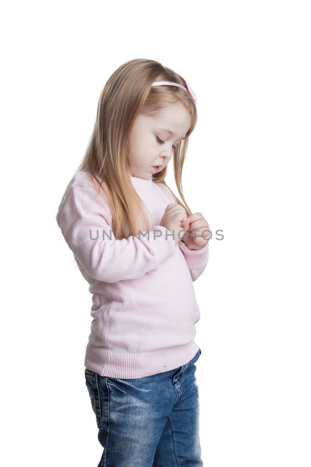 Cute little girl in sweater and jeans. Isolated on white