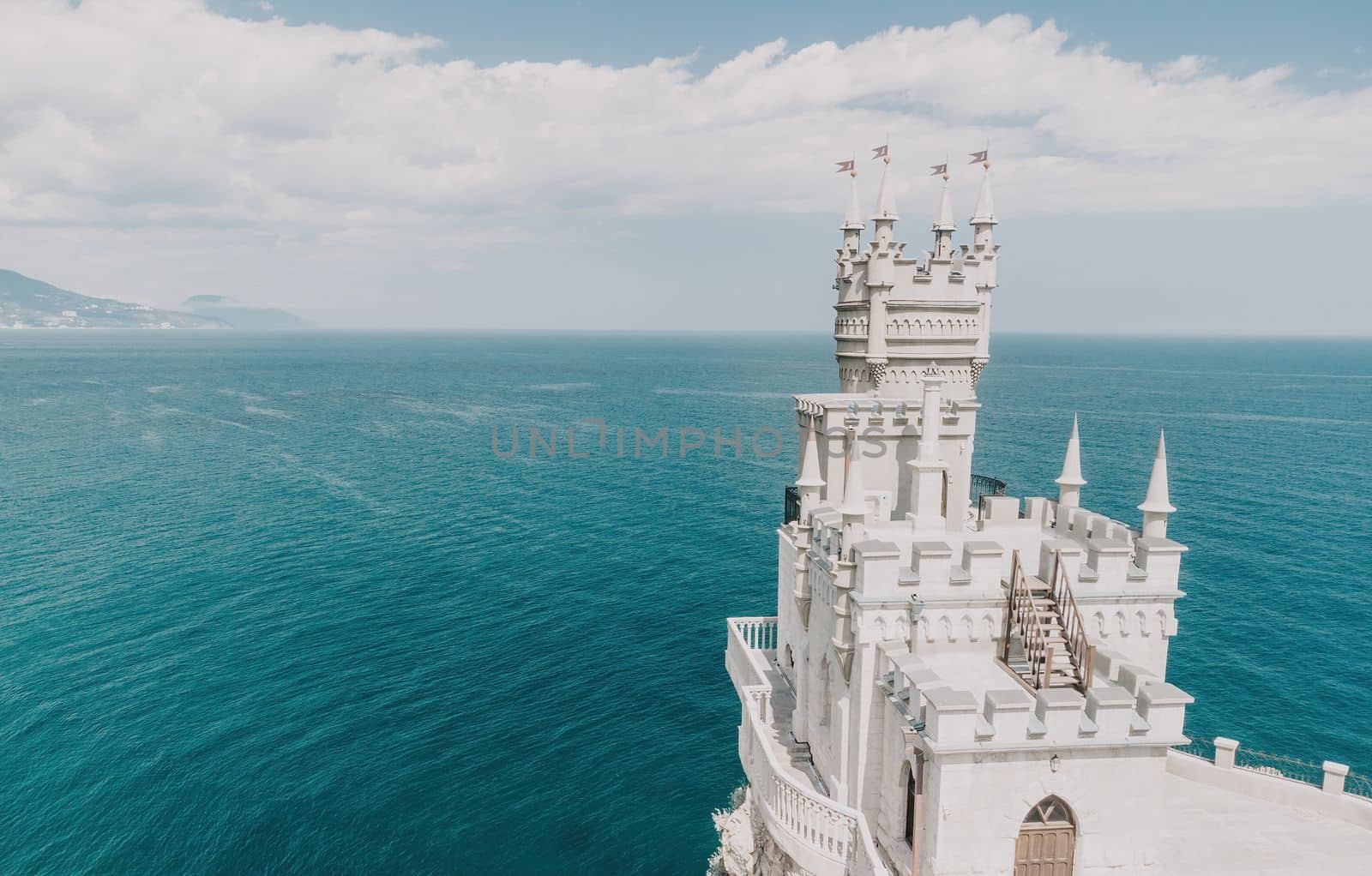 Aerial view of Swallow's Nest castle on the rock in Black Sea. It is a symbol and landmark of Crimea. Beautiful scenic panorama of the Crimea coast. Amazing Swallow's Nest at the precipice.