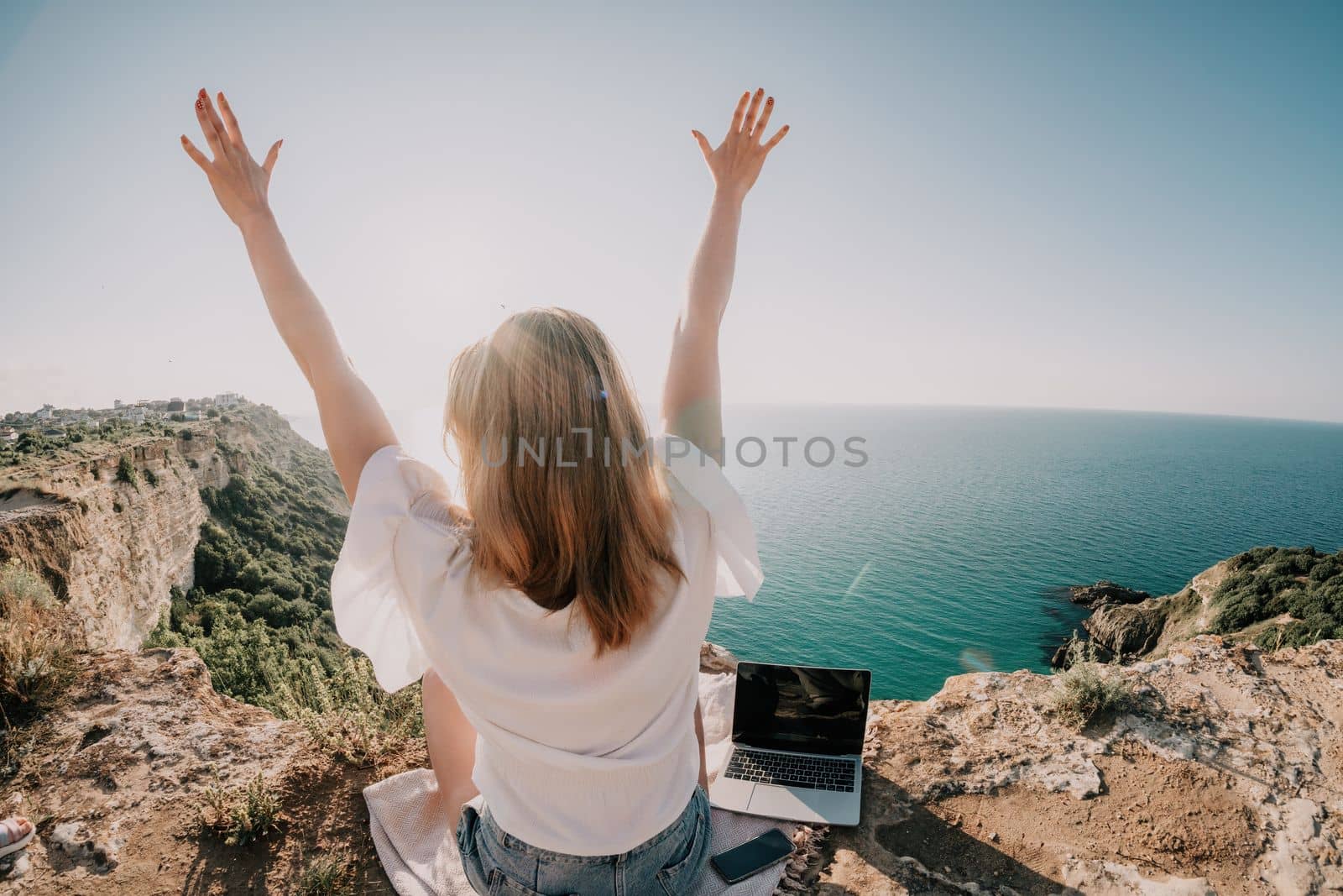 Woman sea laptop. Business woman working on laptop by sea at sunset. Close up on hands of pretty lady typing on computer outdoors summer day. Freelance, digital nomad, travel and holidays concept. by panophotograph