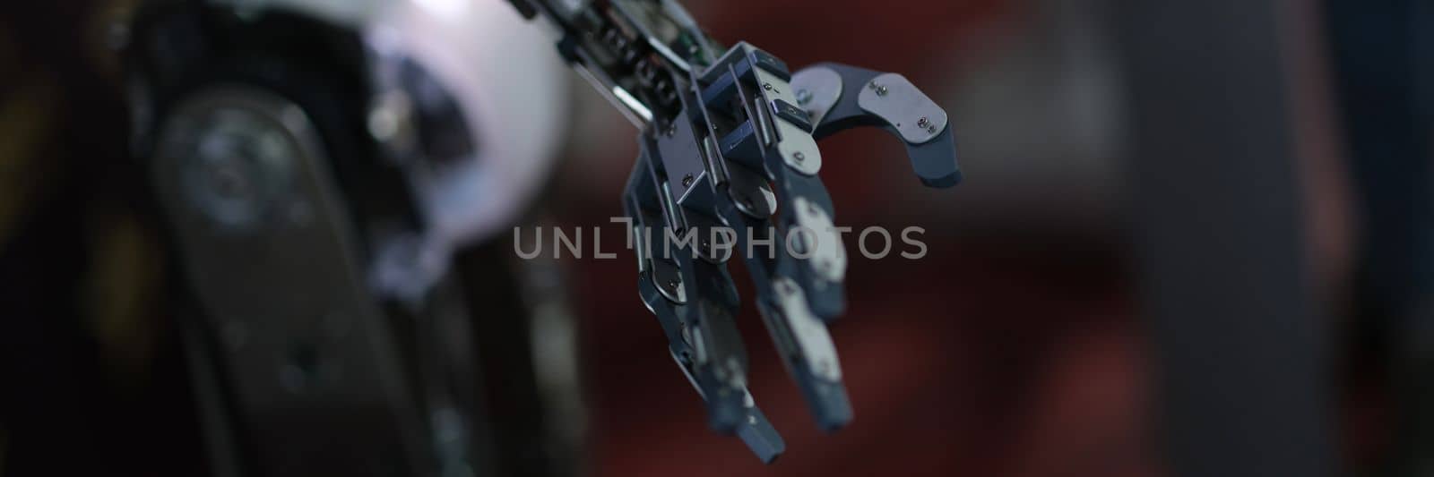 Futuristic black robot arm on black background. Artificial arm and prosthesis concept