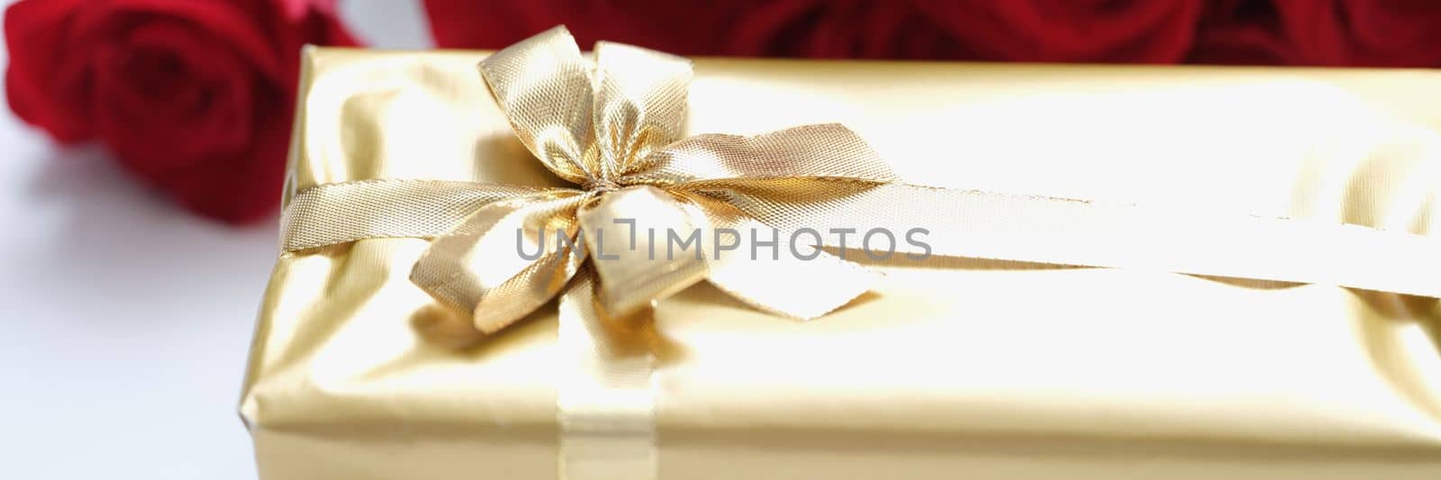 Golden gift box for valentine day with red rose flowers by kuprevich