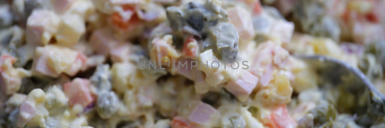 Olivier salad and food ingredients green peas cucumber potatoes sausage and mayonnaise by kuprevich