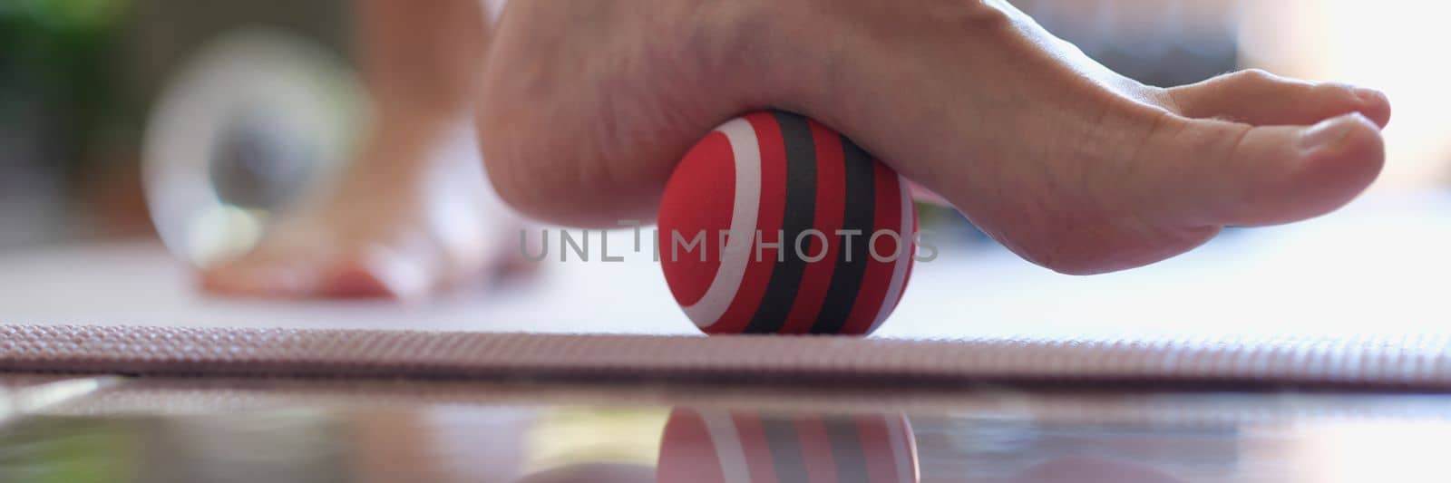 Female heel massage with massage tool for myofascial therapy closeup. Ball for myofascial massage concept