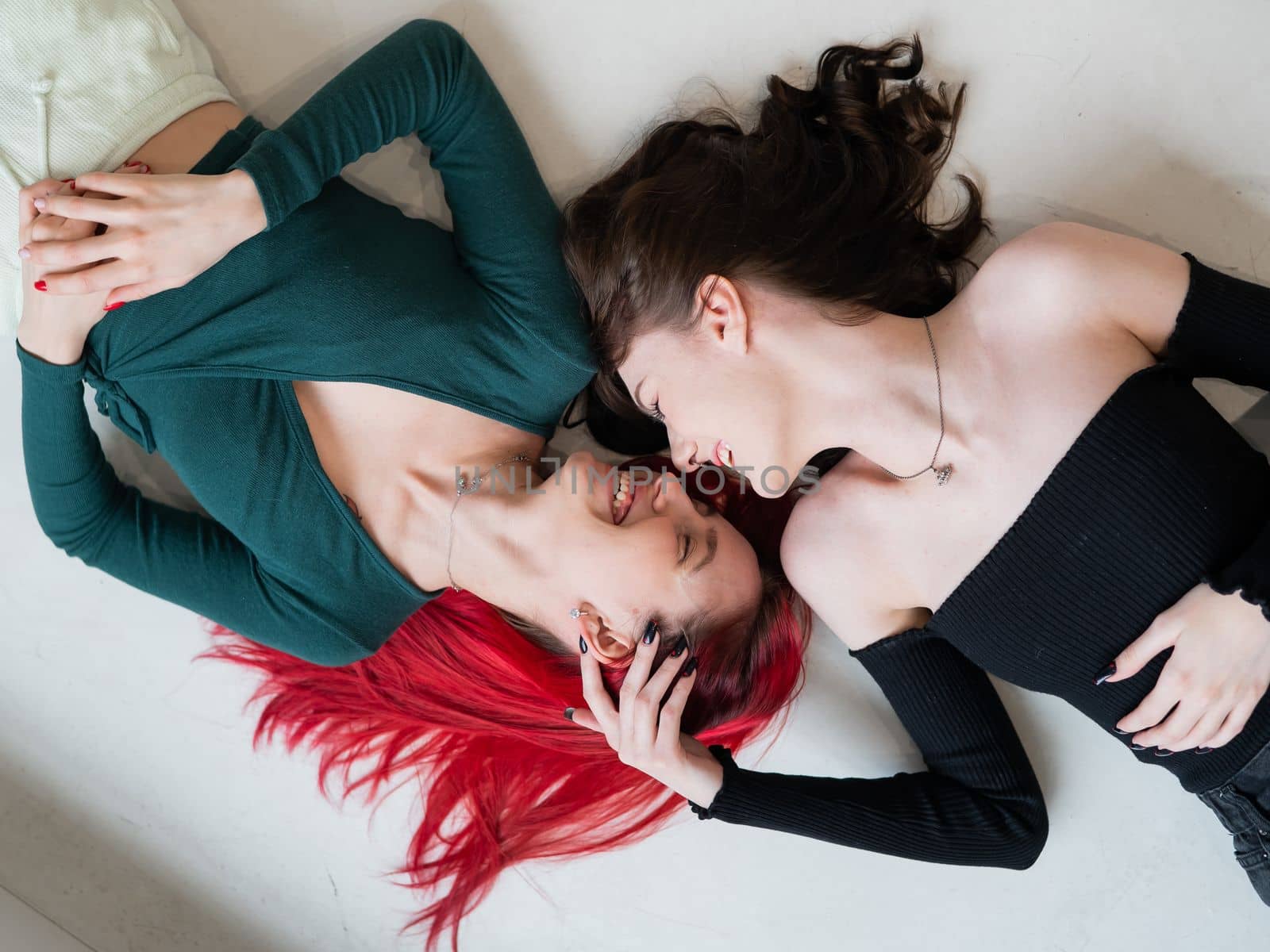 Top view of caucasian women lying and kissing