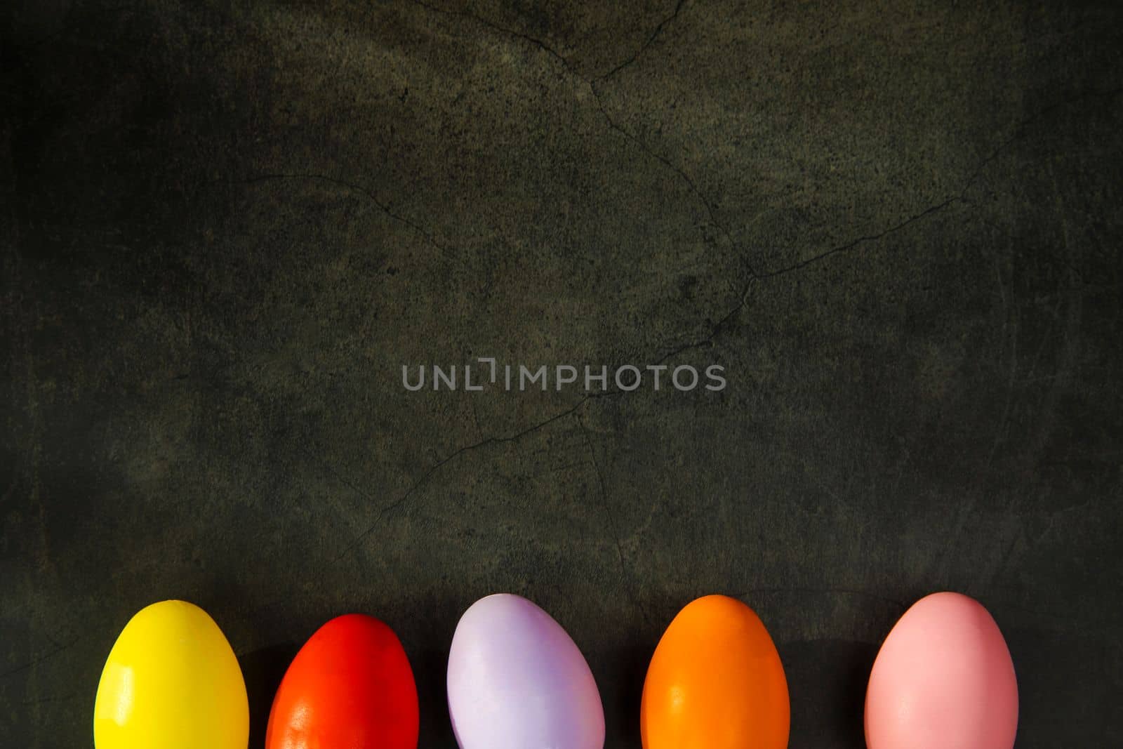 dyed colorful Easter eggs on grey concrete background top view. Holiday banner, card, concept, design. copy space Happy Easter holiday concept