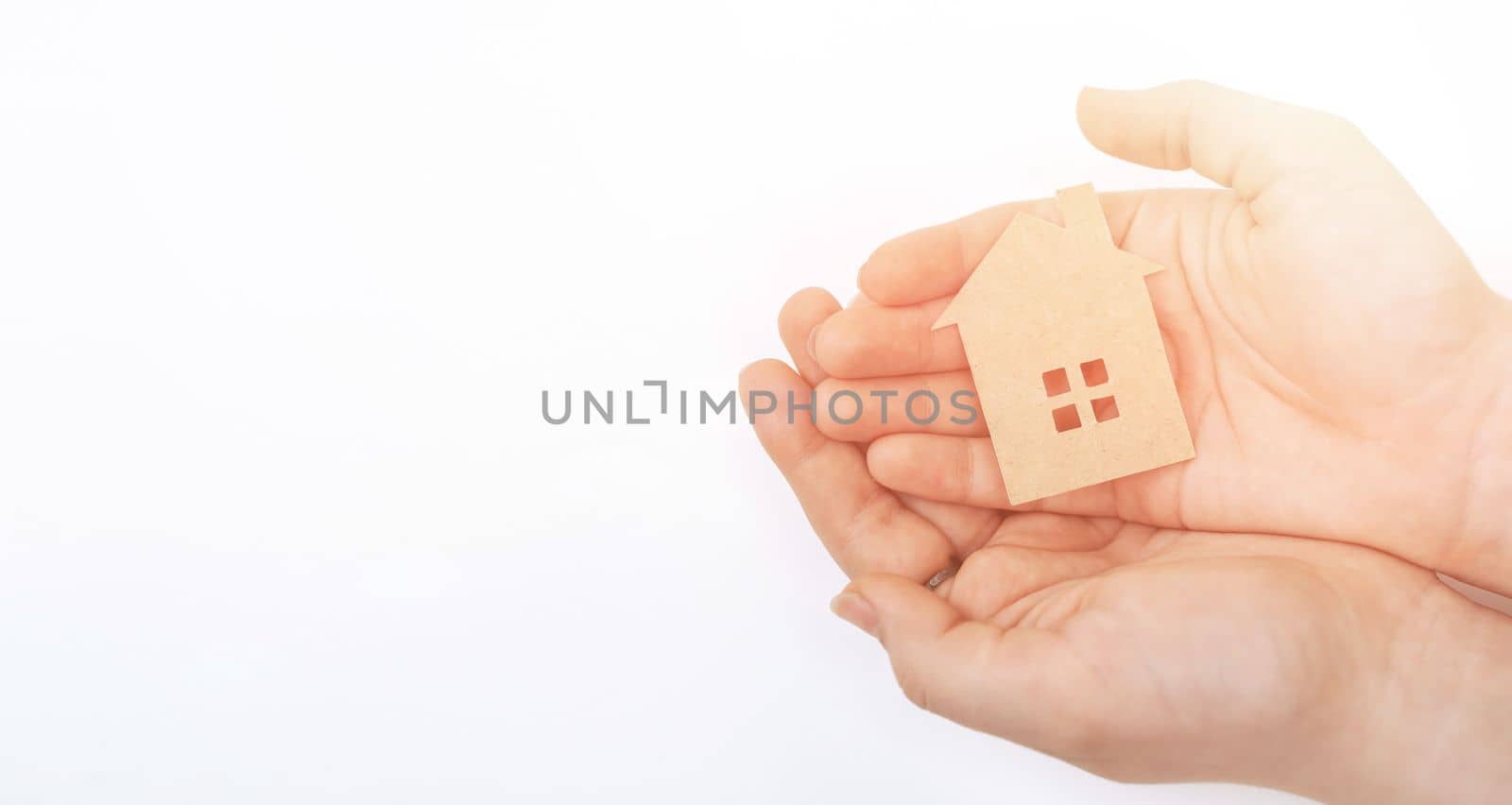 hands holding paper house, family home, homeless housing, mortgage crisis and home protecting insurance concept, foster home care, family day care, social distancing