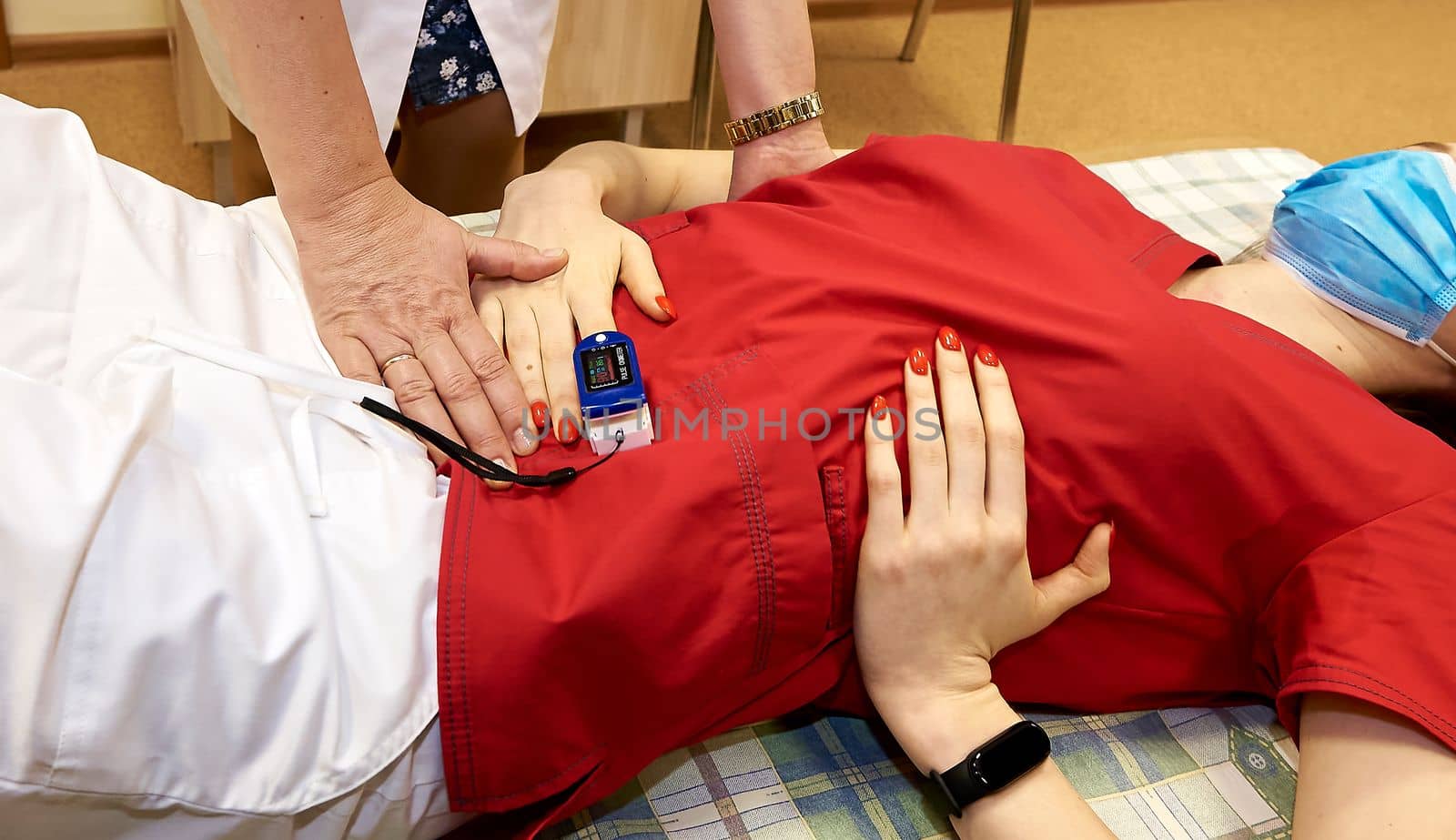 Pulse oximeter on the patient's arm. Surgical equipment. Oxygen saturation in the blood.
