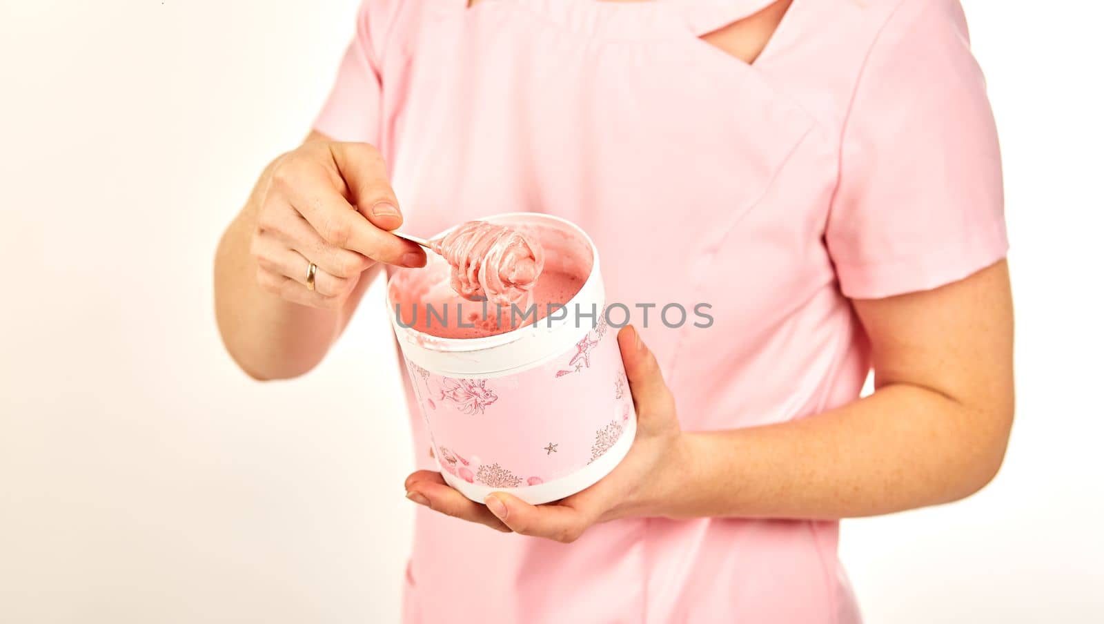 Woman holding sugar paste for hair removal. Depilation in a beauty salon.