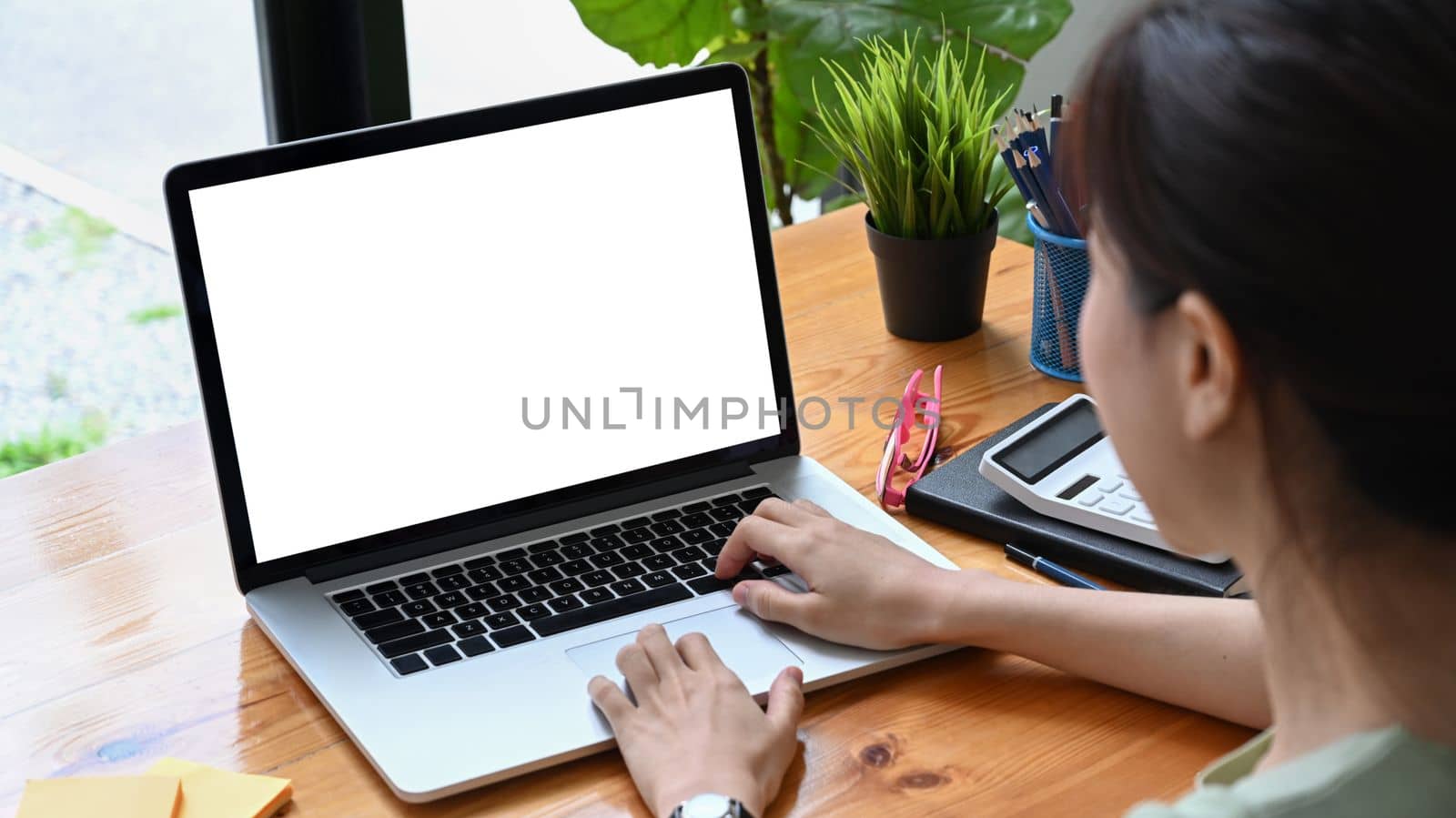 Female accountant working with computer laptop. by prathanchorruangsak