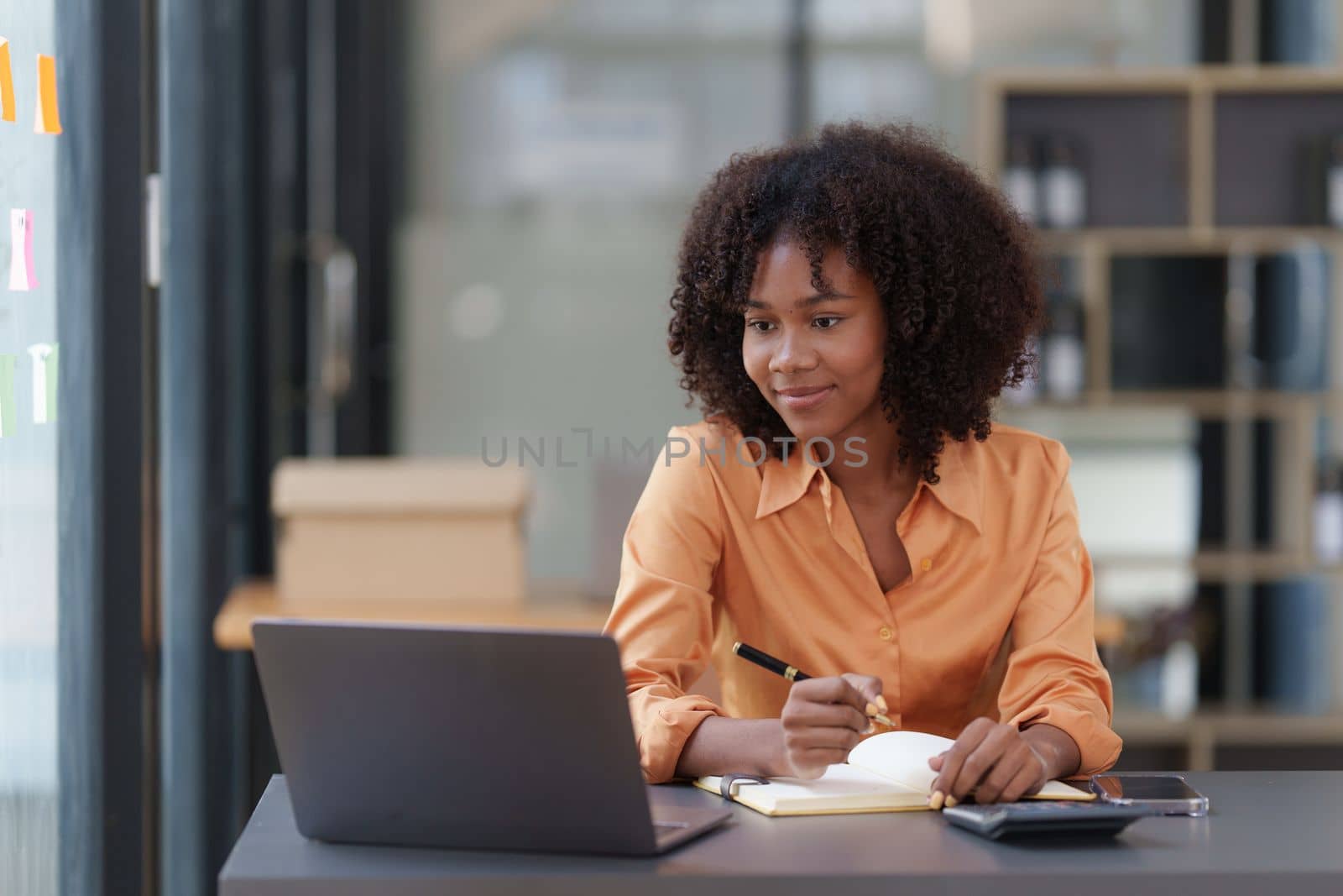 Accountant black woman working on laptop and do document, tax, exchange, accounting and Financial advisor concept by itchaznong