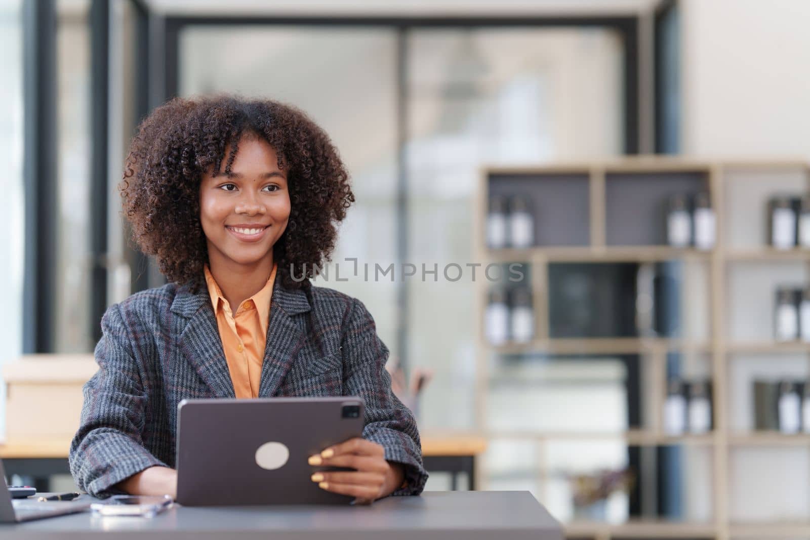 Accountant black woman working on digital tablet and do document, tax, exchange, accounting and Financial advisor concept by itchaznong