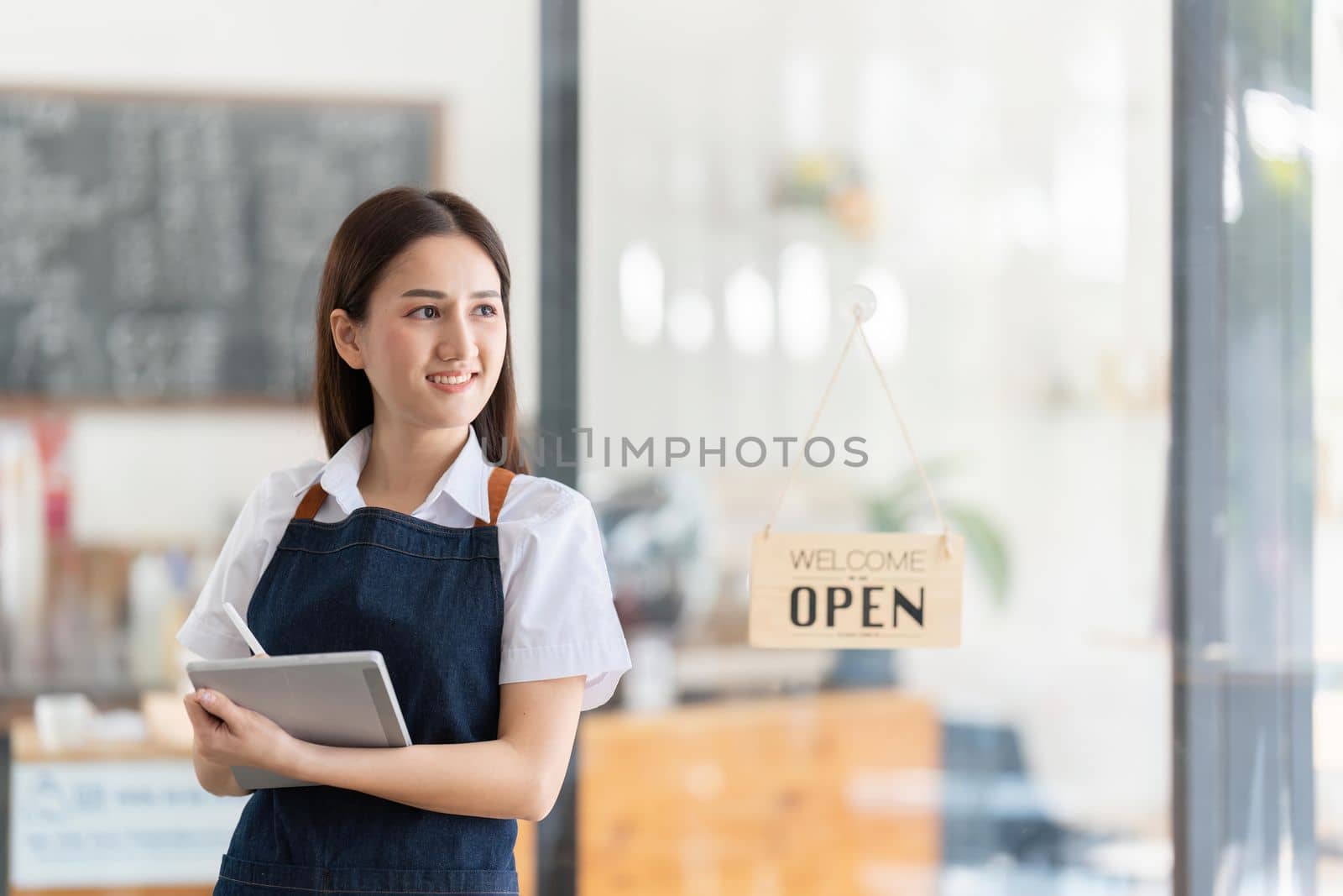 Portrait of a Bright smiling woman prepares to open a shop to welcome customers