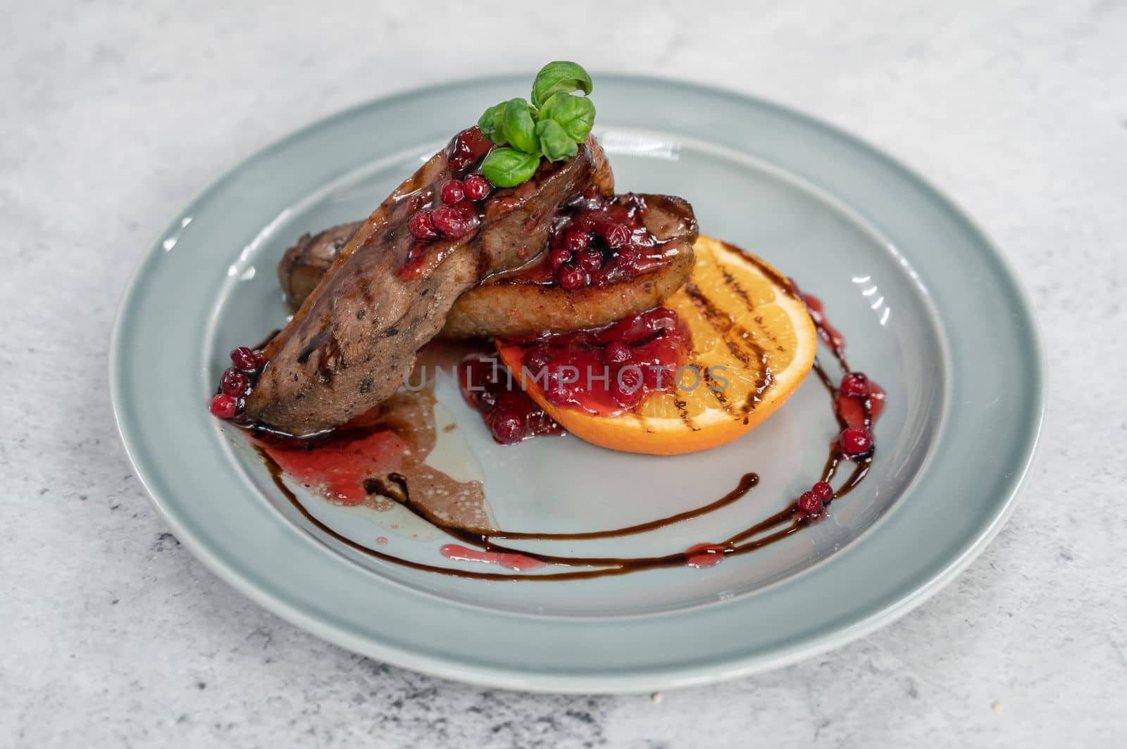 Tasty duck breast with orange and berries