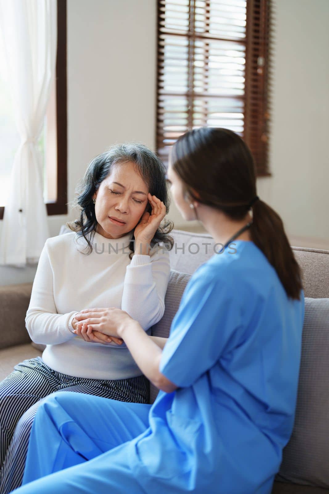 Portrait of a female doctor holding a patient's hand to encourage the fight against disease