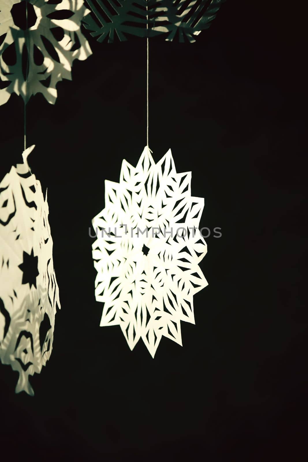 Paper snowflakes in home interior. Christmas and New year decor.