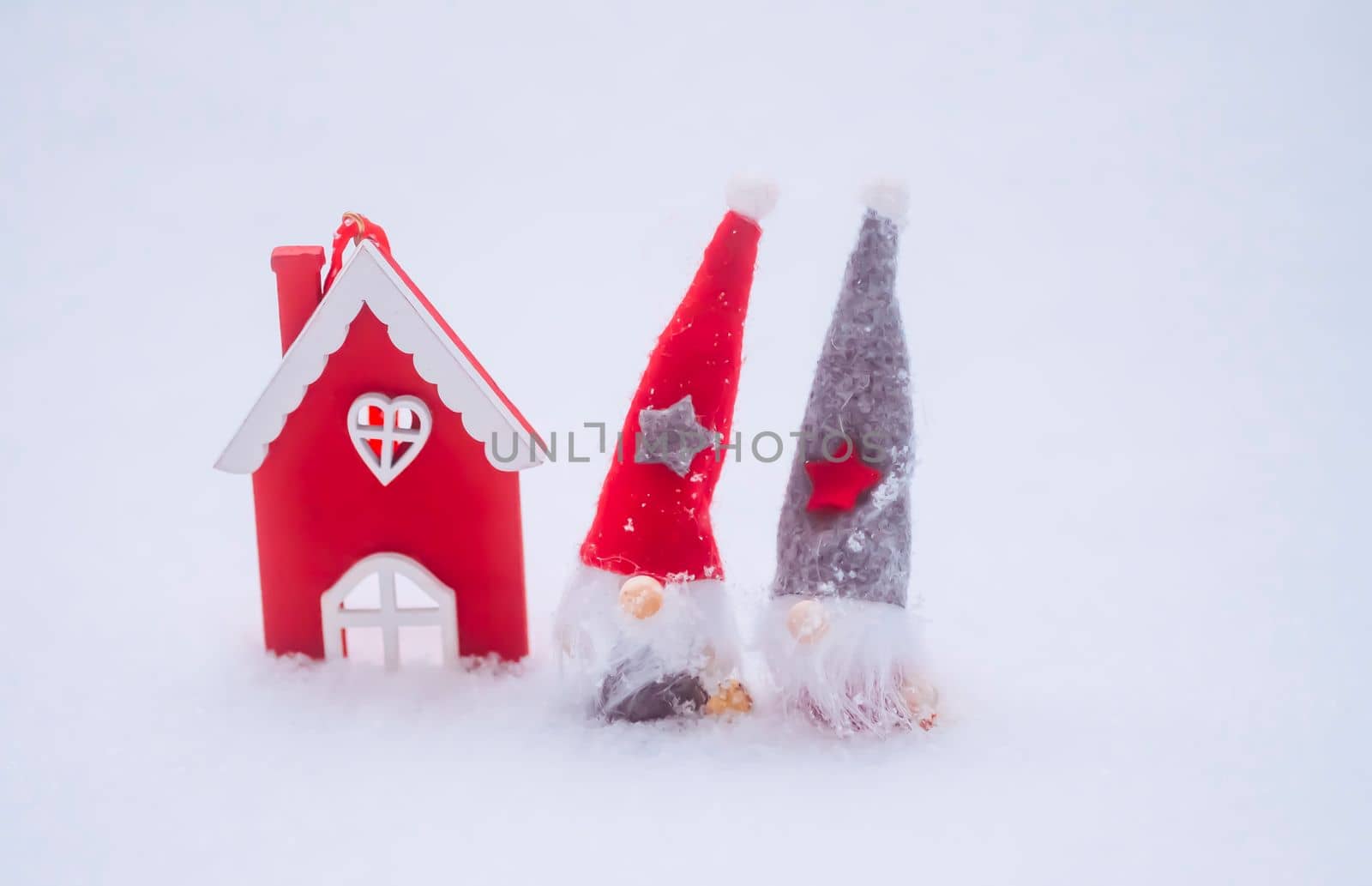 Cute gnomes in red hat and wooden house. Decorative Christmas toys by nightlyviolet