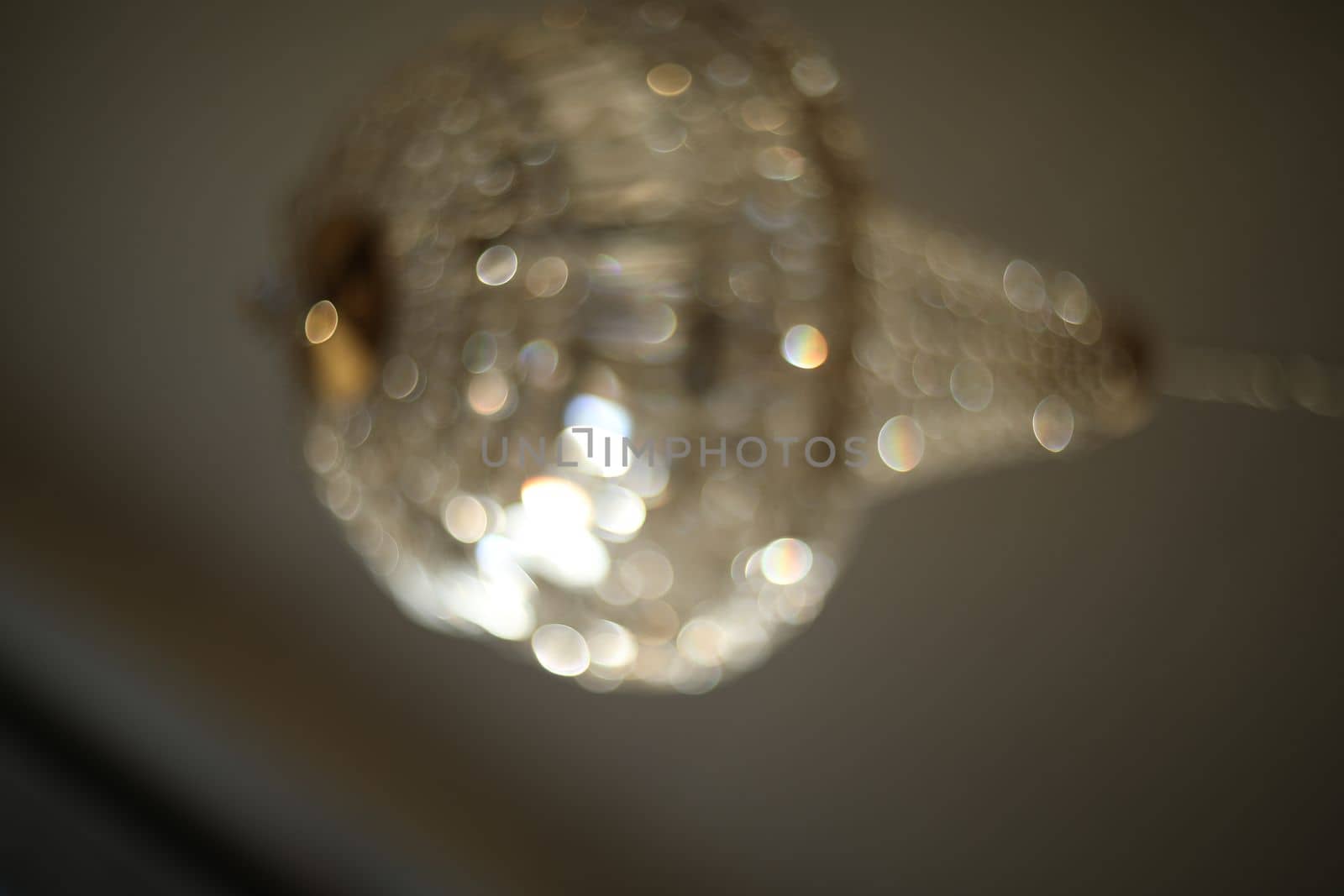 blurred crystal chandelier bokeh out of focus. Glamour background with copy space