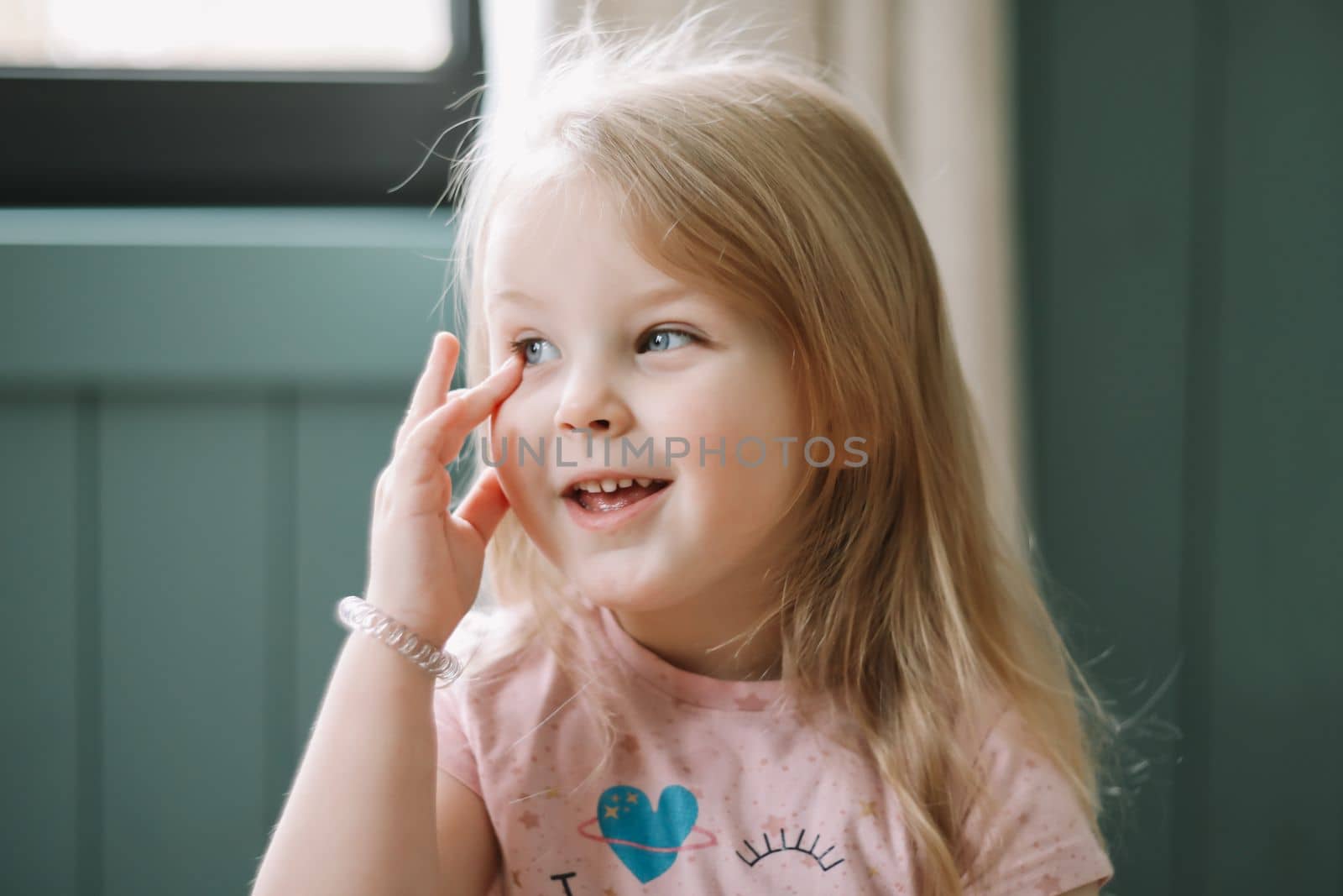 Portrait of a lovely little girl at home. Attractive lovely sweet curious cheerful smart toddler girl.