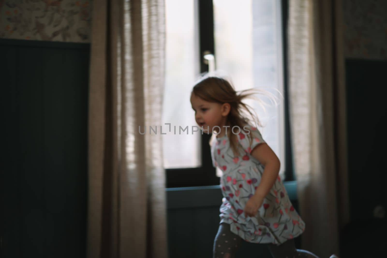 Portrait of a lovely little girl at home. Attractive lovely sweet curious cheerful smart toddler girl.