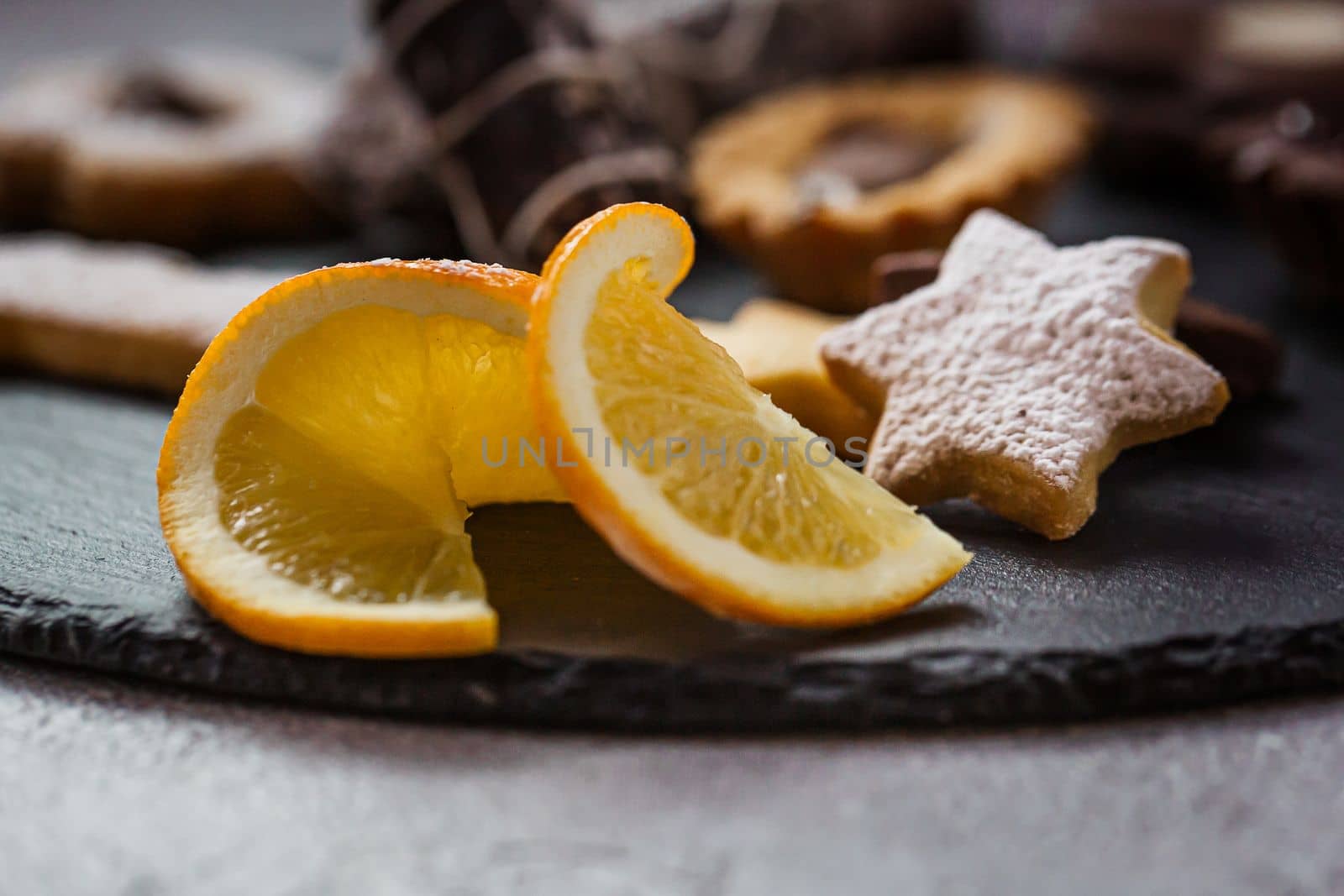 Tasty homemade Christmas cookies on black plate, closeup view