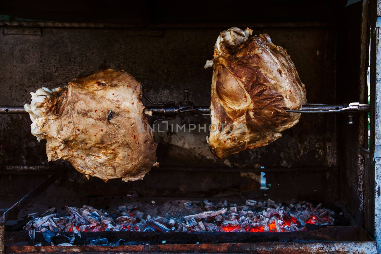 Chicken thighs Barbecue on The Hot Grill Close-up. Fire flames in the background