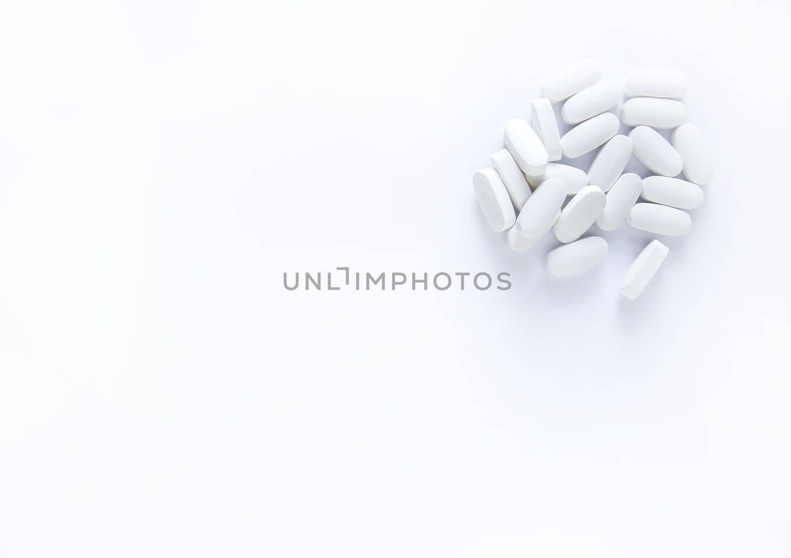 Pills of vitamin on soft light background.