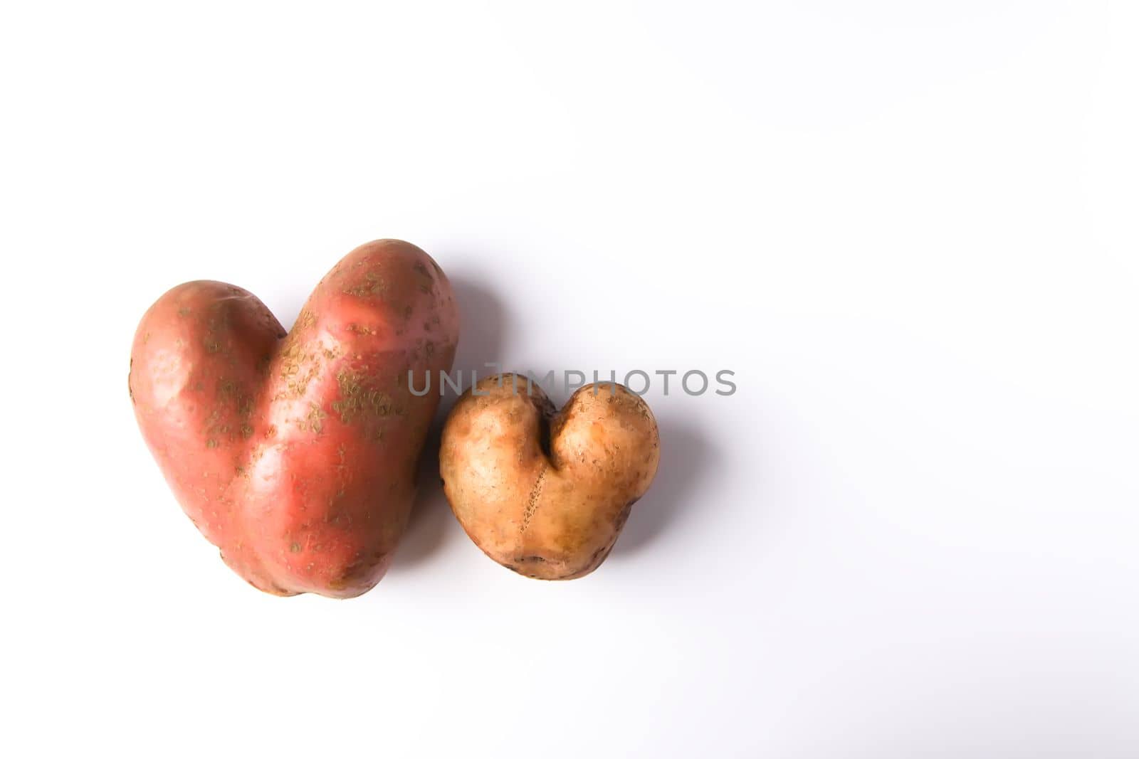 Heart shaped raw potato vegetables.Top view, copy space.