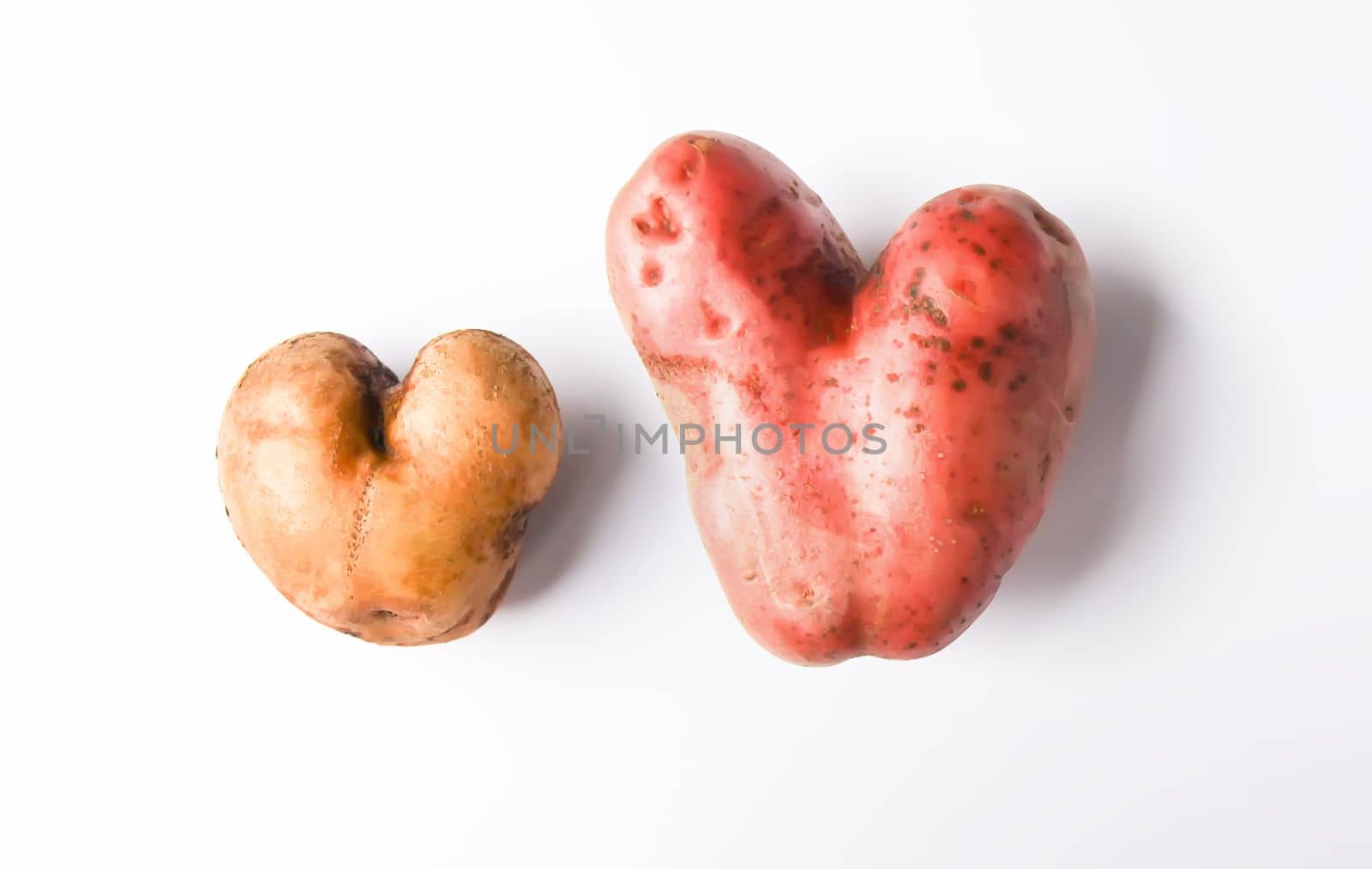 Heart shaped raw potato vegetables.Top view, copy space. by nightlyviolet