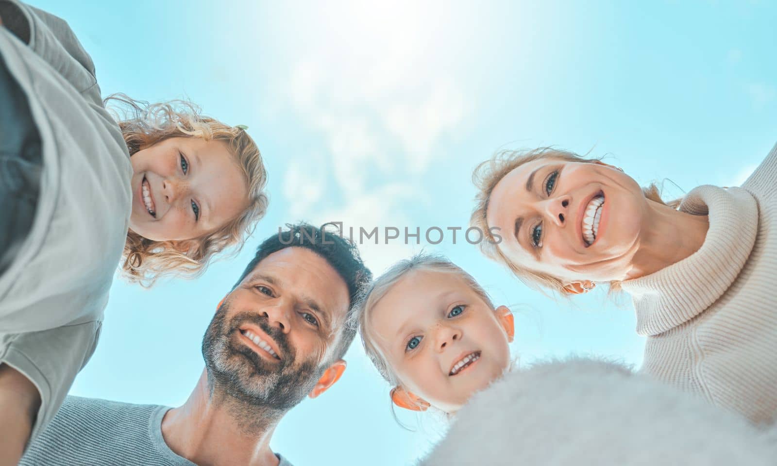 Family gives you the roots to stand tall and strong. a family spending time together outside. by YuriArcurs