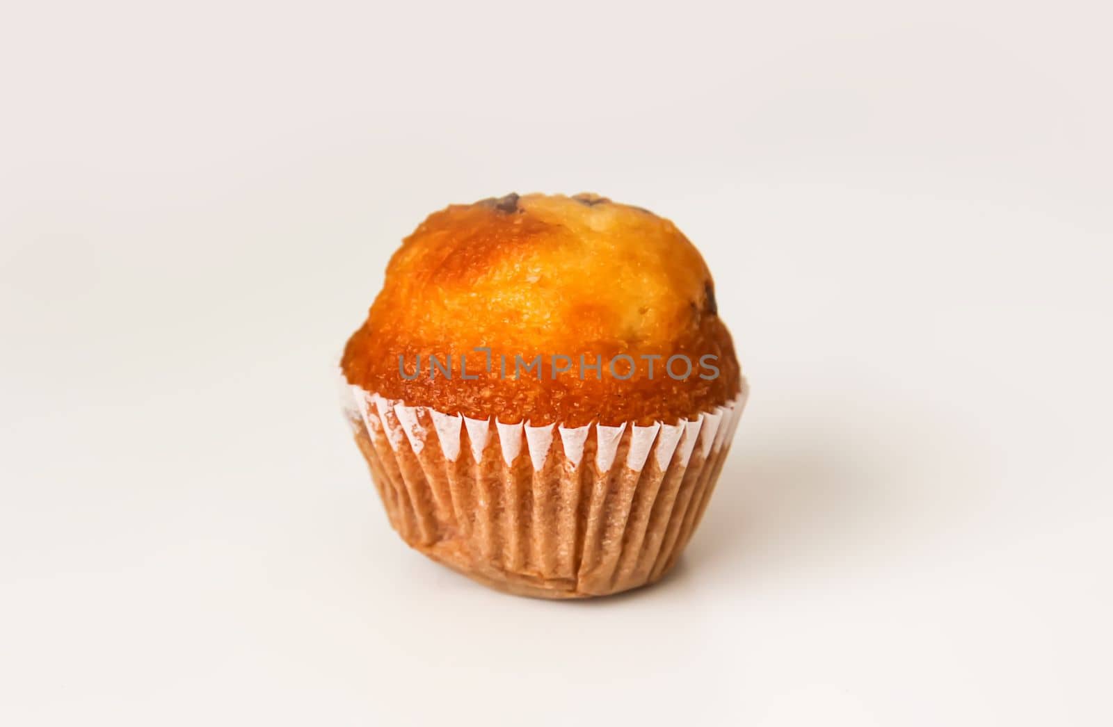 Sweet muffin cup cake closeup on white background. by nightlyviolet