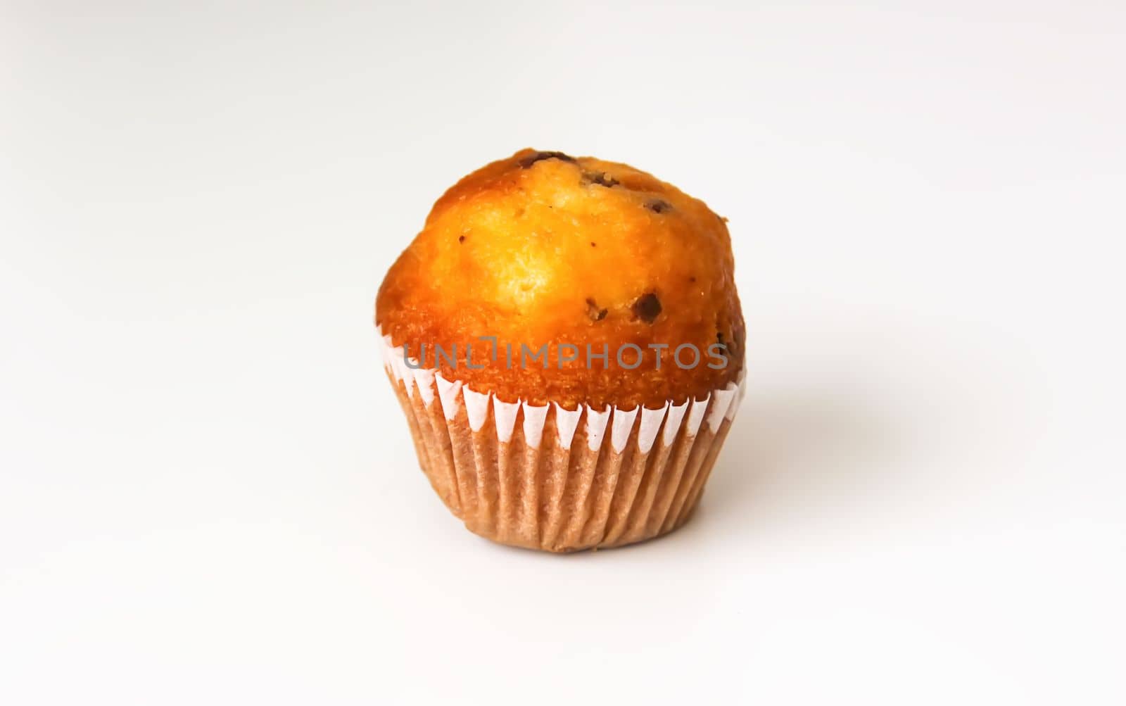 Sweet muffin cup cake closeup on white background.