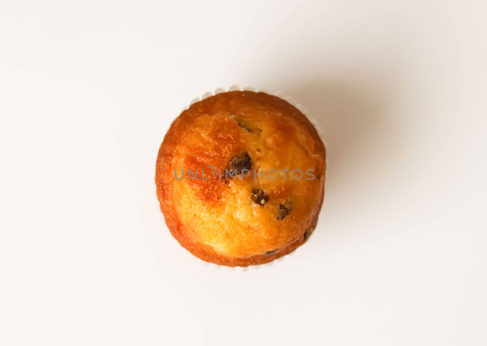 Sweet muffin cup cake closeup on white background.