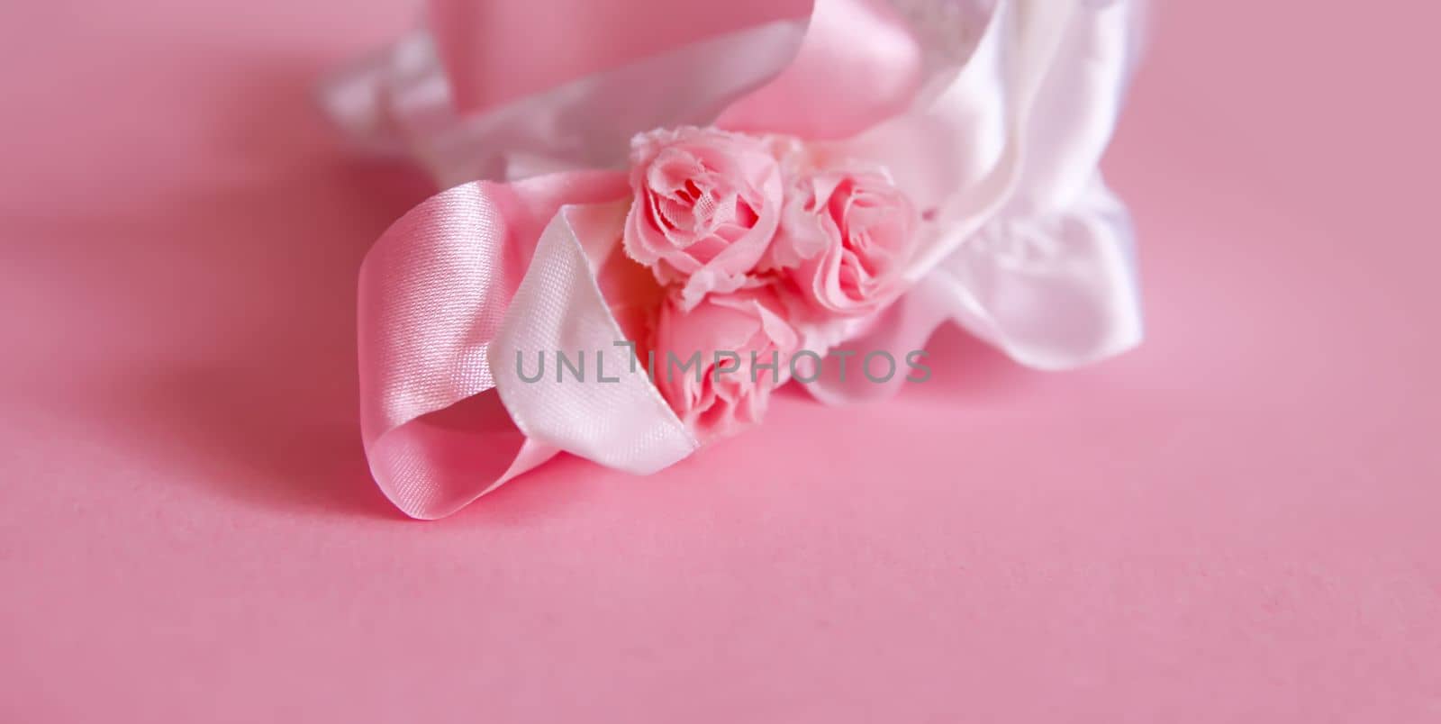 The bride's garter on a pink background. by nightlyviolet