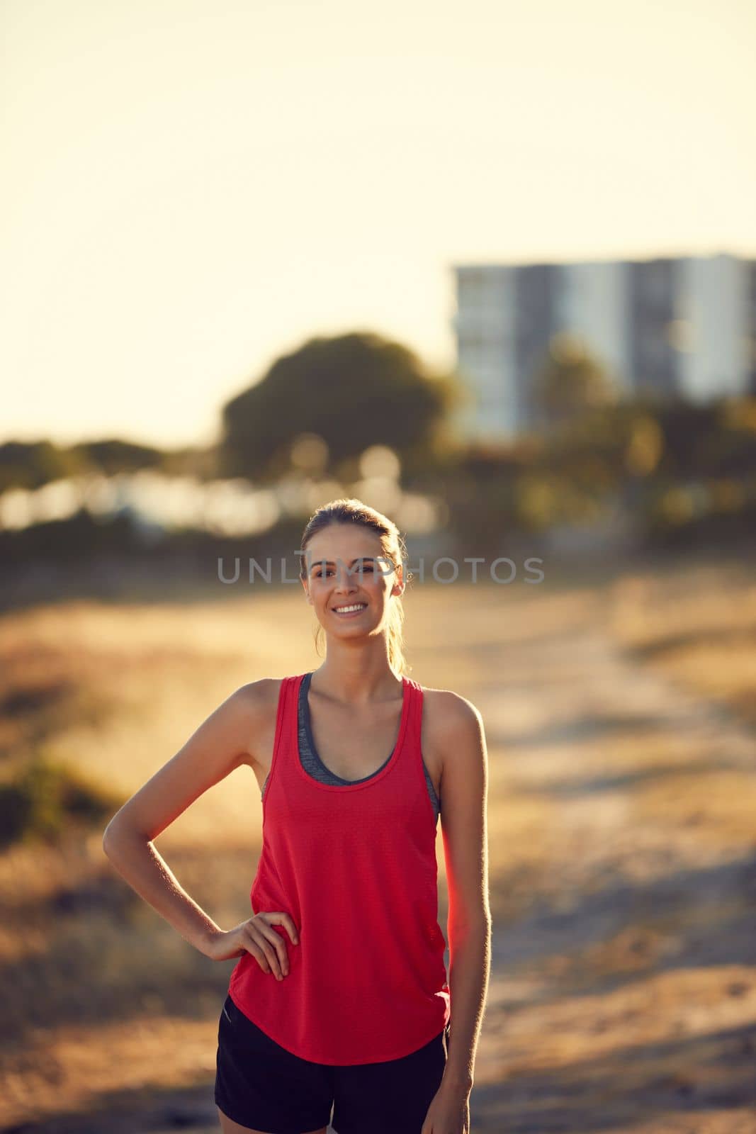 Today is about getting into top form. Portrait of a sporty young woman exercising outdoors