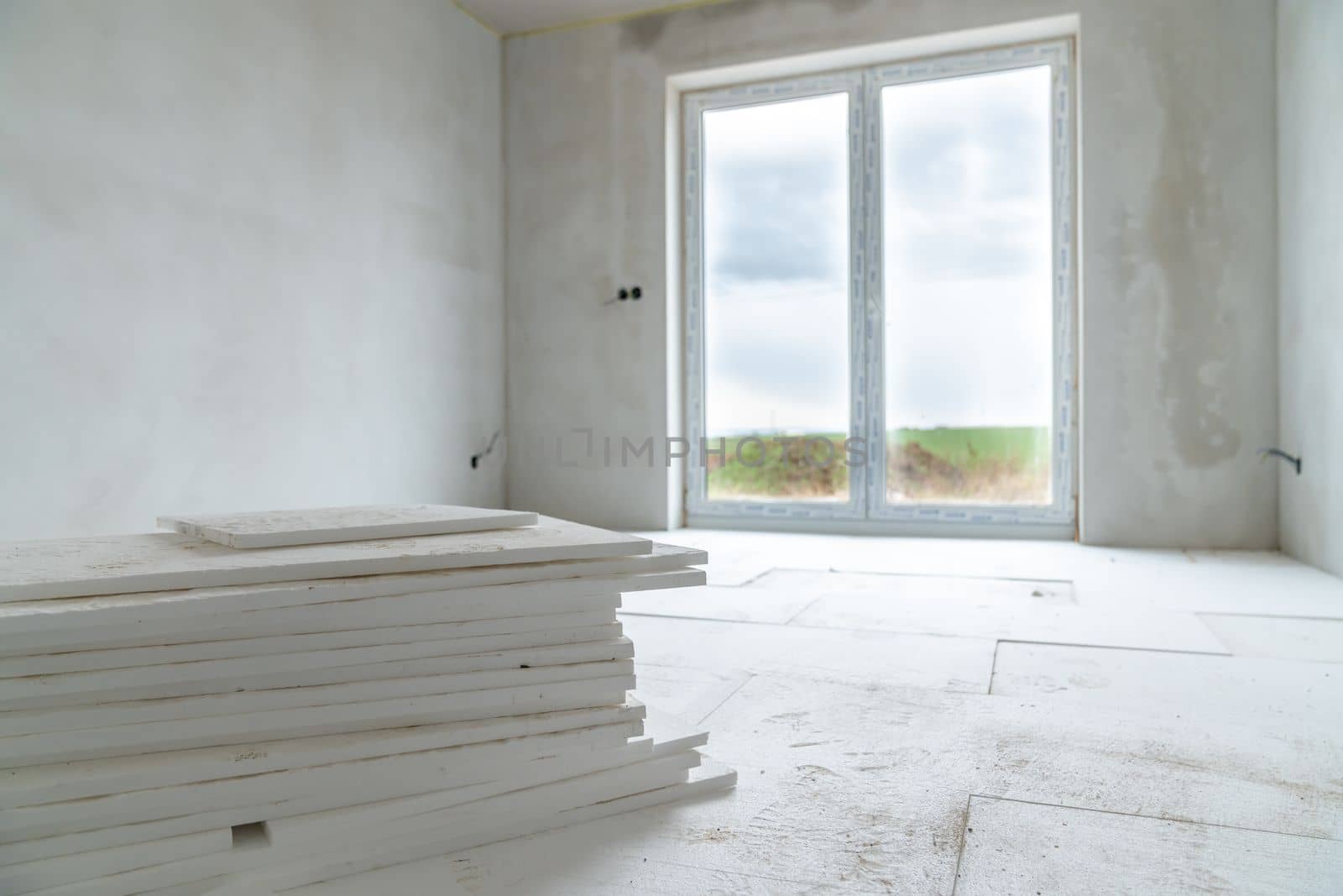 insulation of floors with polystyrene on the construction site.