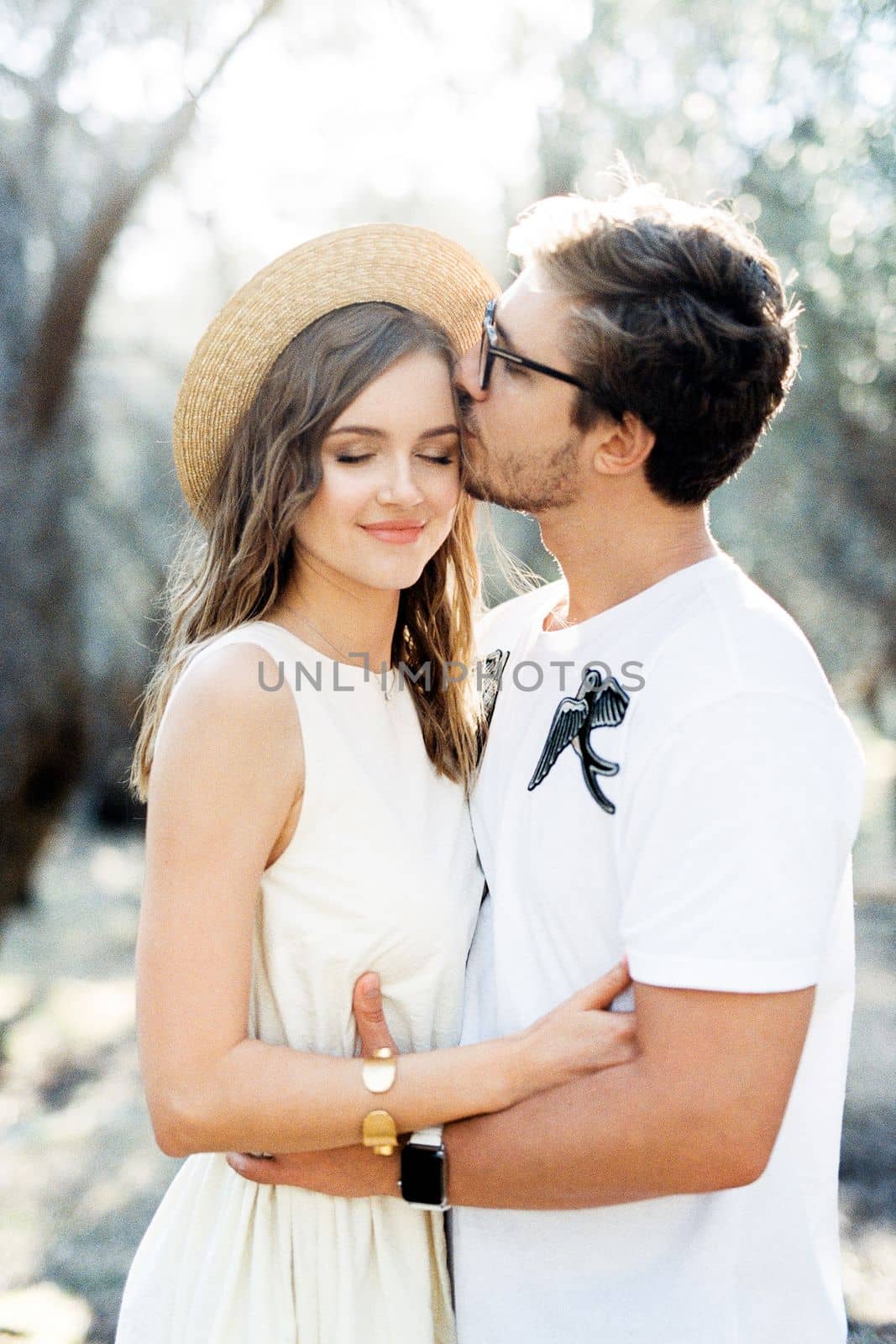 Man hugs and kisses woman on the forehead. High quality photo