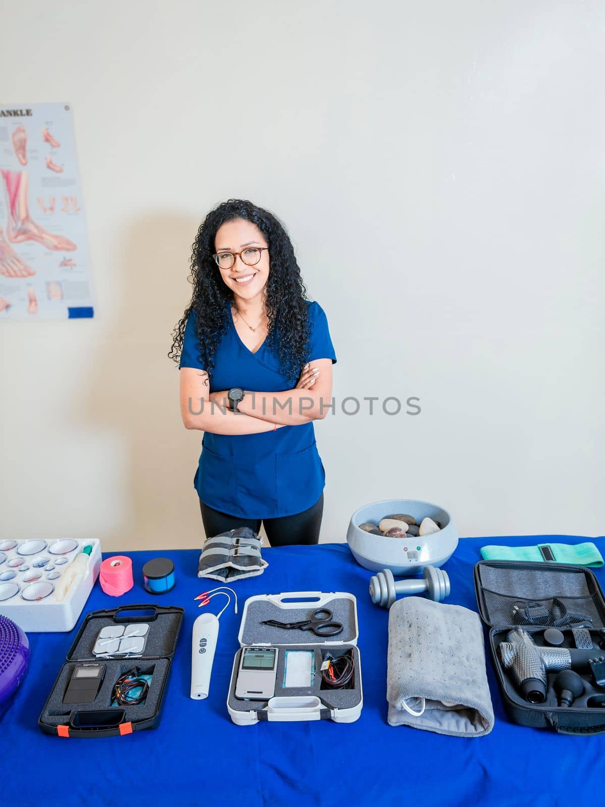 Physiotherapist with physiotherapy accessories. Smiling physiotherapist showing physiotherapy accessories, Physiotherapist woman showing therapy accessories and equipment