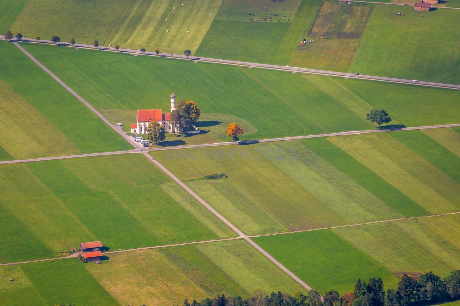 St. Coleman's Church in idyllic Bavarian alps meadows, Germany, border with Austria