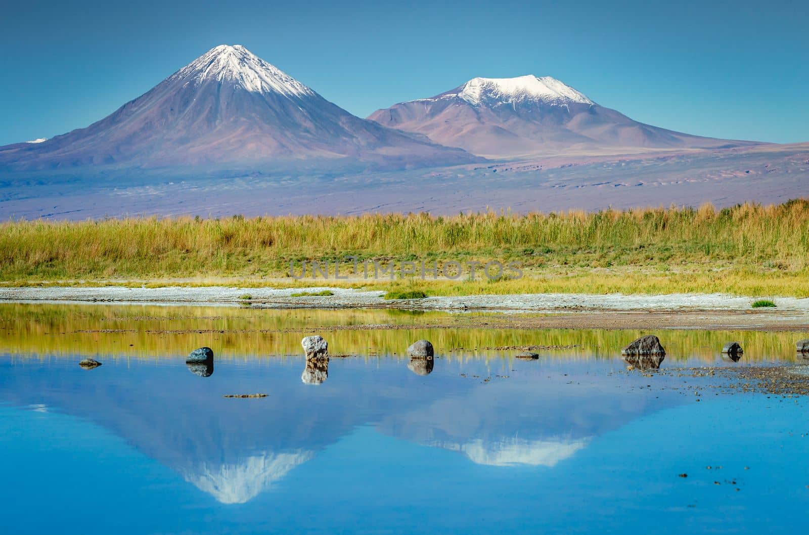 Licancabur and Peaceful reflection lake with dramatic volcanic landscape at Sunset, Atacama Desert, Chile