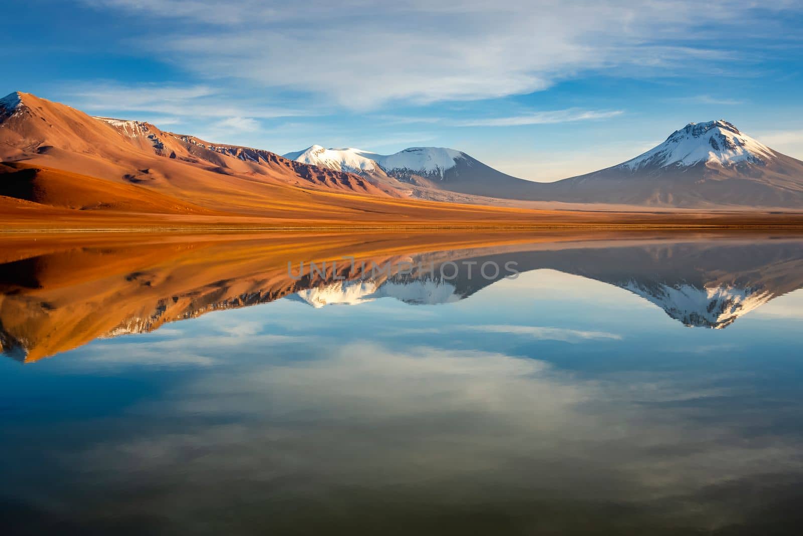 Salt lake Lejia reflection and idyllic volcanic landscape at Sunset, Atacama desert, Chile